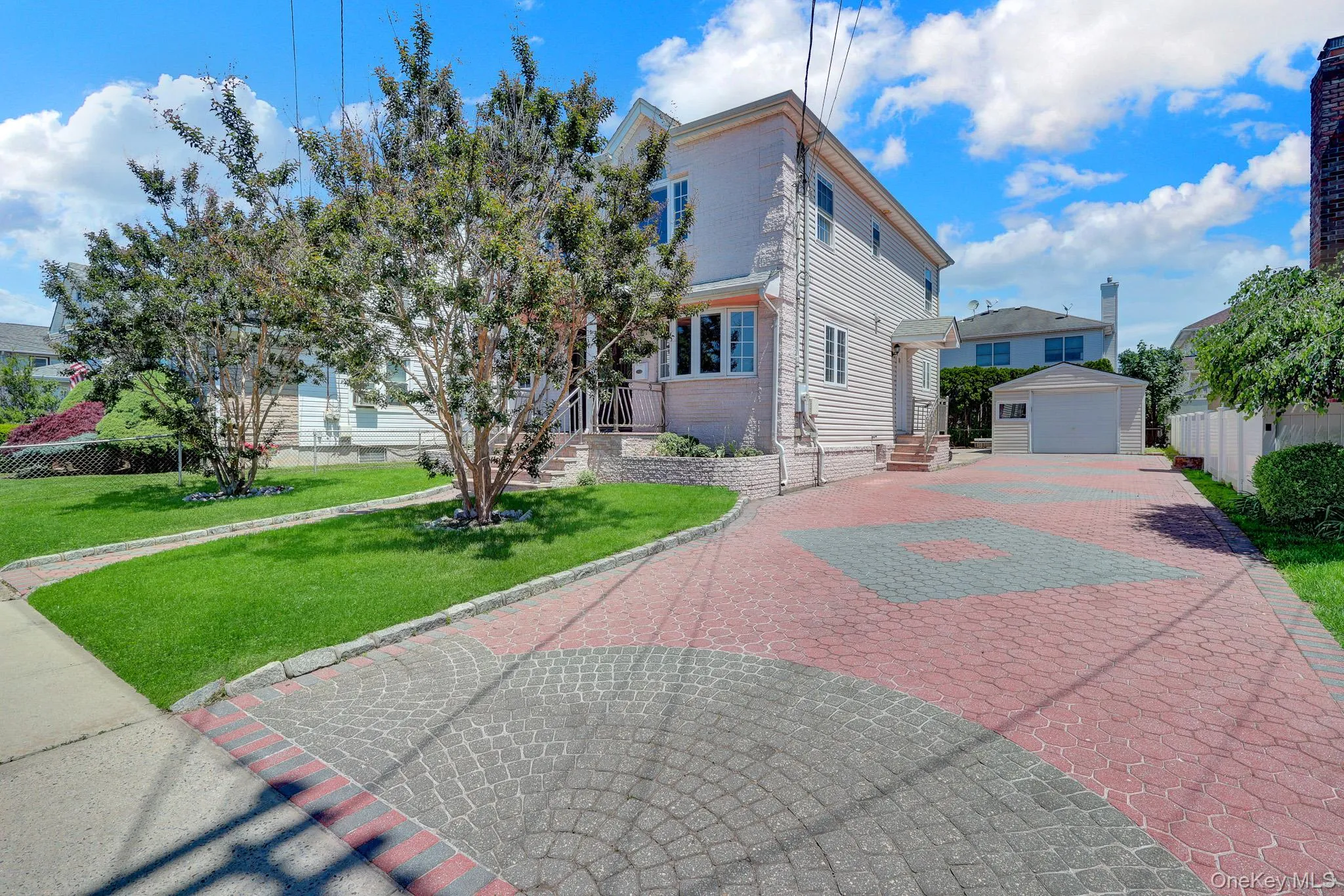 Substantial paver driveway with decorative patterns Substantial paver driveway with decorative patterns