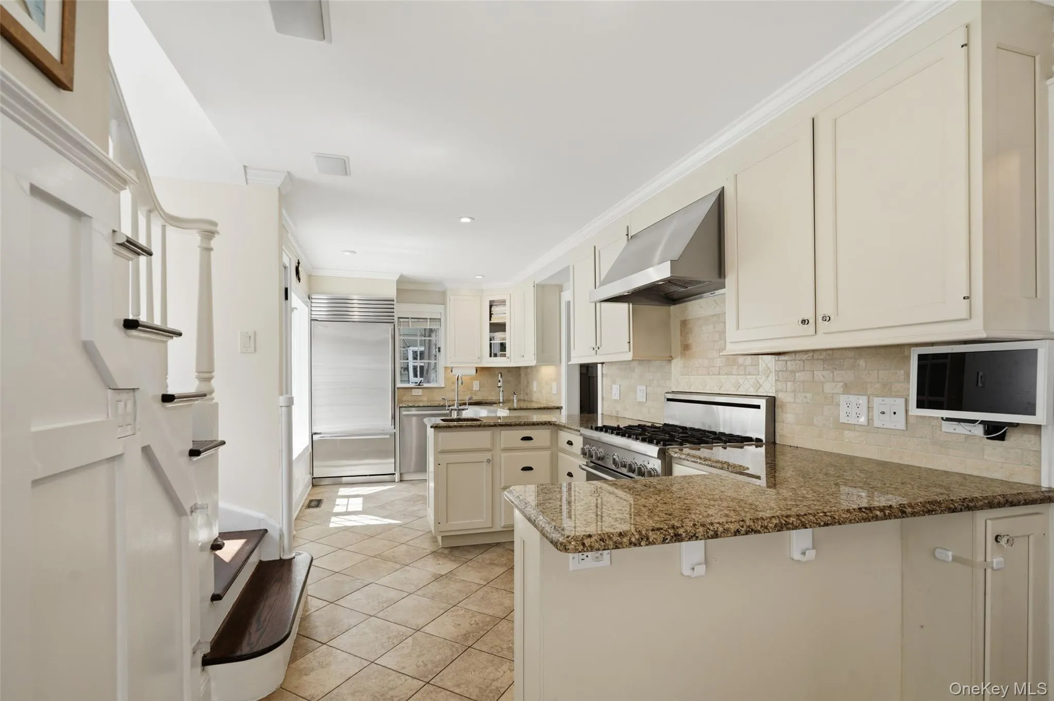 Kitchen with stairs to second floor, plentiful counter space and gas range. Kitchen with stairs to second floor, plentiful counter space and gas range.