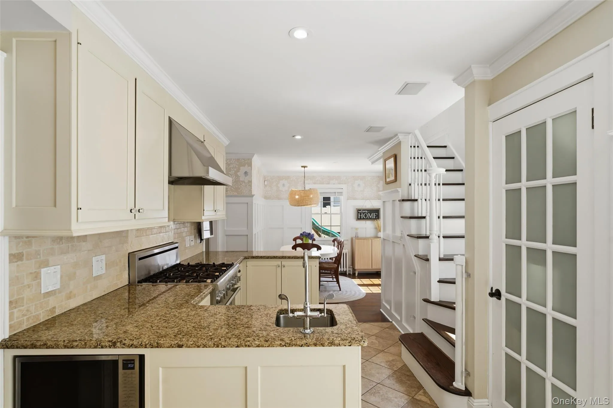 Kitchen with stairs leading to second floor, with pantry. Kitchen with stairs leading to second floor, with pantry.