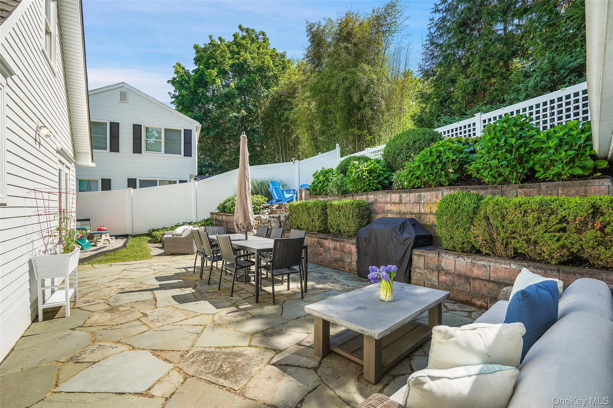 Tiered back patio with multiple seating areas Tiered back patio with multiple seating areas