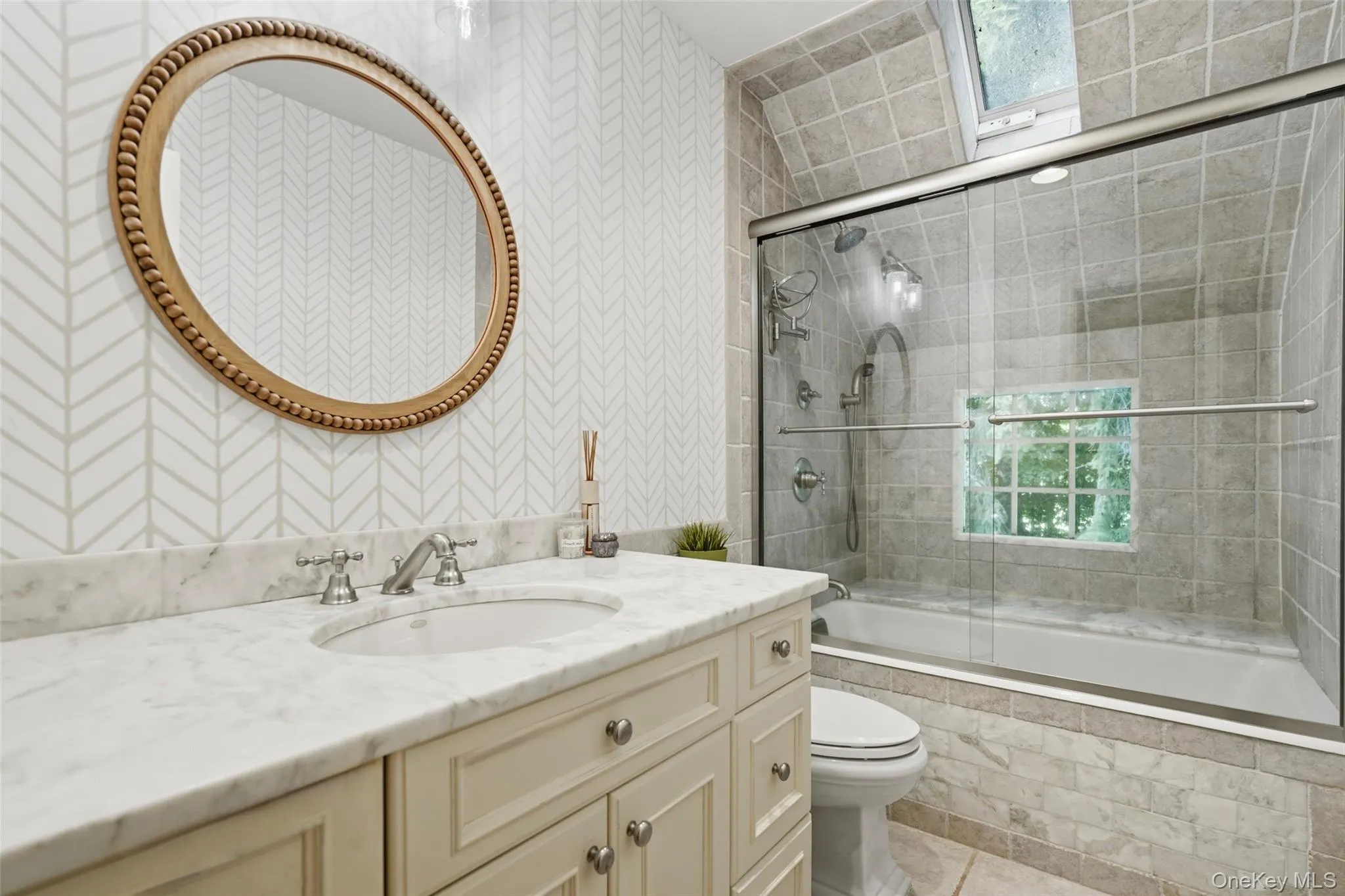 Primary bathroom featuring skylight. Primary bathroom featuring skylight.