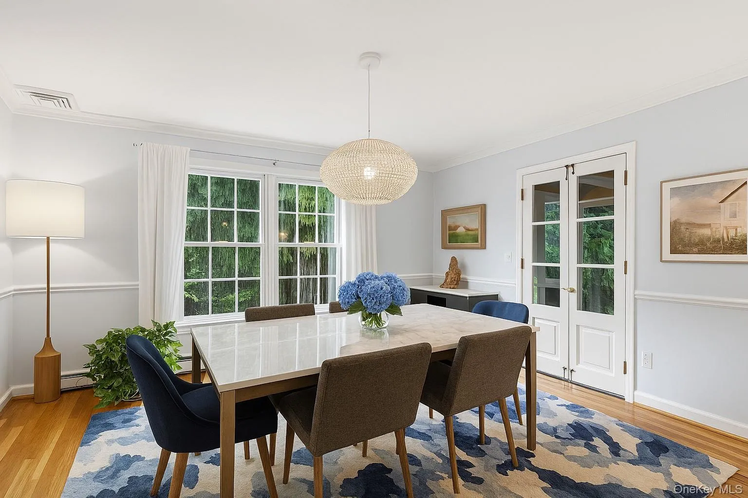 Dining room with doors to screened in porch. Dining room with doors to screened in porch.