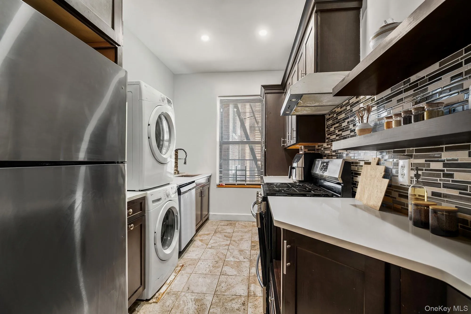 Kitchen with the capability of being stacked on top of the washer and dryer by removing the top cabinet.Virtually staged. Kitchen with the capability of being stacked on top of the washer and dryer by removing the top cabinet.Virtually staged.
