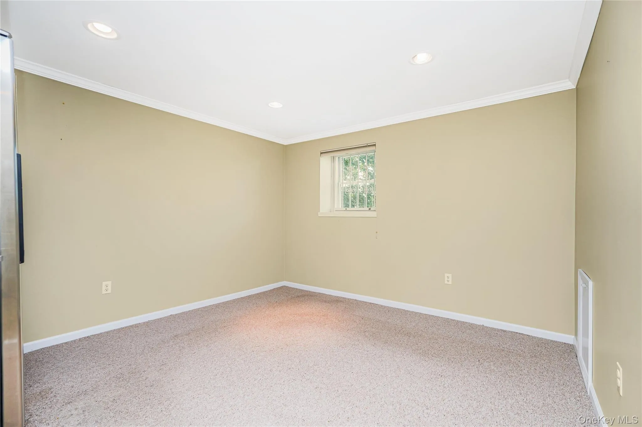 Carpeted room featuring recessed lighting, a window with exterior tree views, and white crown molding Carpeted room featuring recessed lighting, a window with exterior tree views, and white crown molding