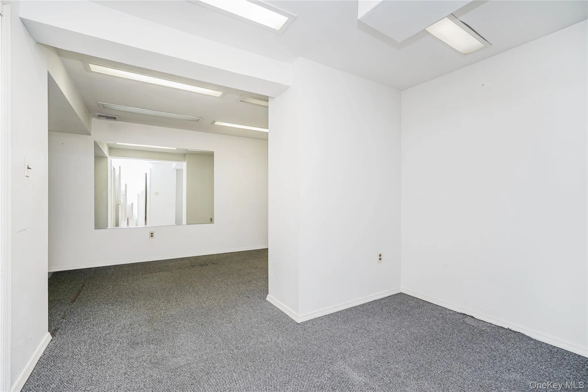 Room featuring grey carpet, white walls, and recessed lighting Room featuring grey carpet, white walls, and recessed lighting