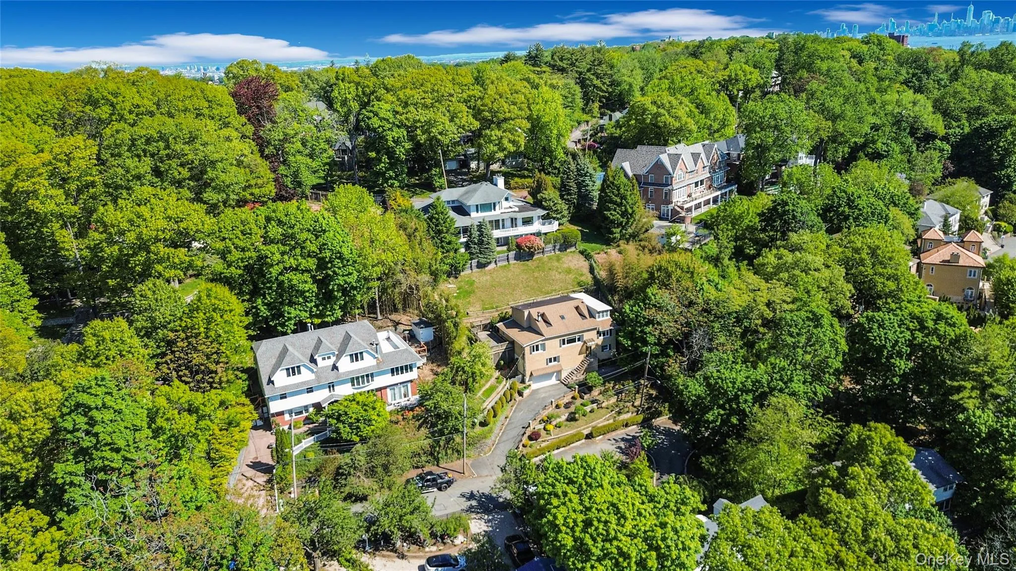Expansive aerial perspective showcasing multiple residential properties nestled among mature trees Expansive aerial perspective showcasing multiple residential properties nestled among mature trees