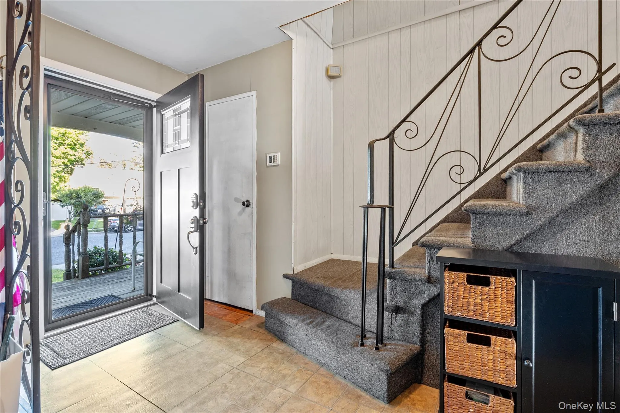 Entryway, a front door with decorative glass, and a storm door Entryway, a front door with decorative glass, and a storm door