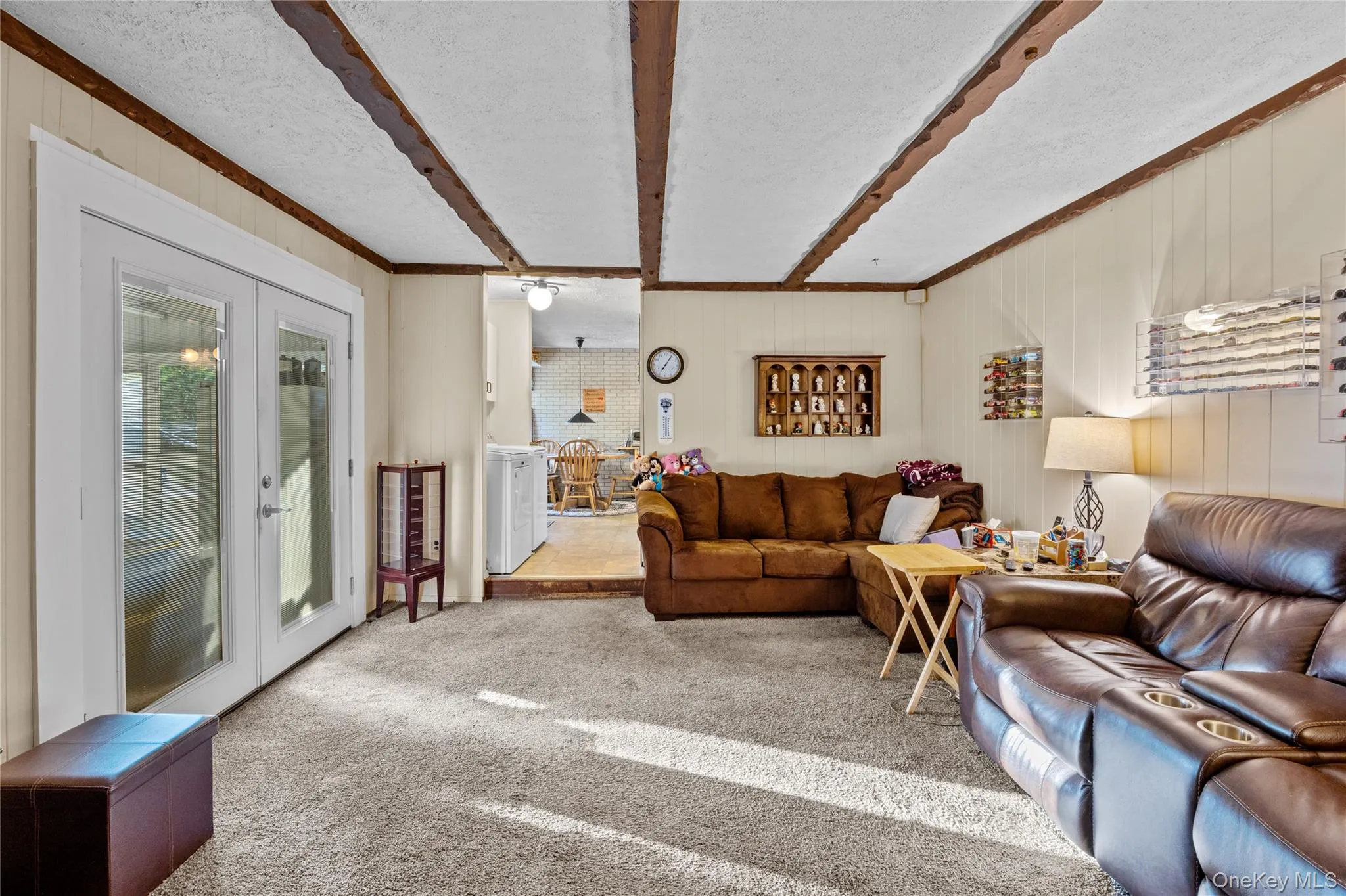 Massive living area featuring exposed ceiling beams Massive living area featuring exposed ceiling beams