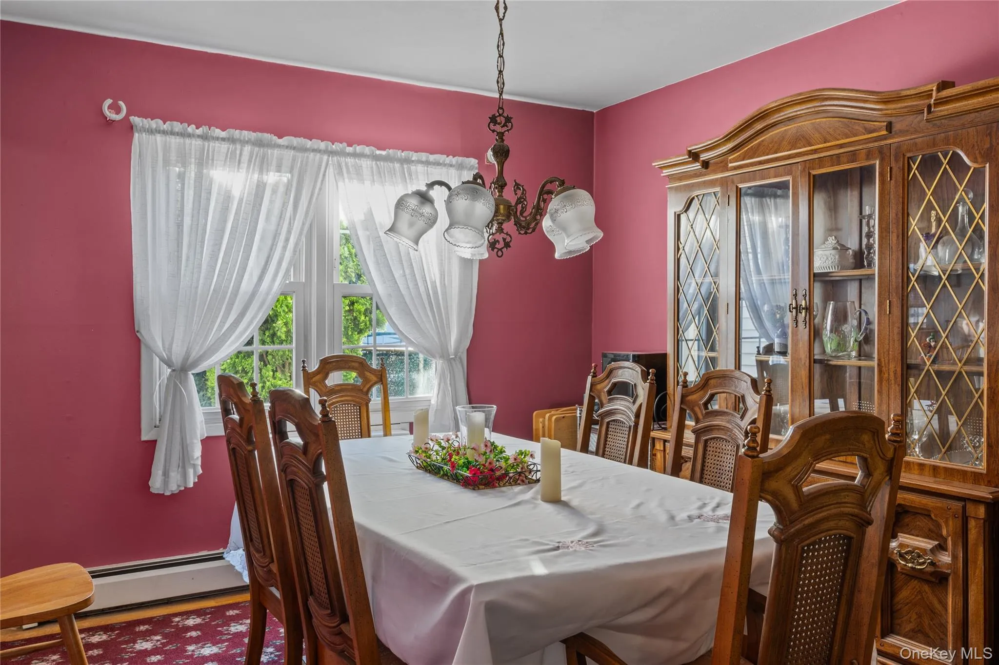 Dining room featuring a central window and an ornate chandelier Dining room featuring a central window and an ornate chandelier