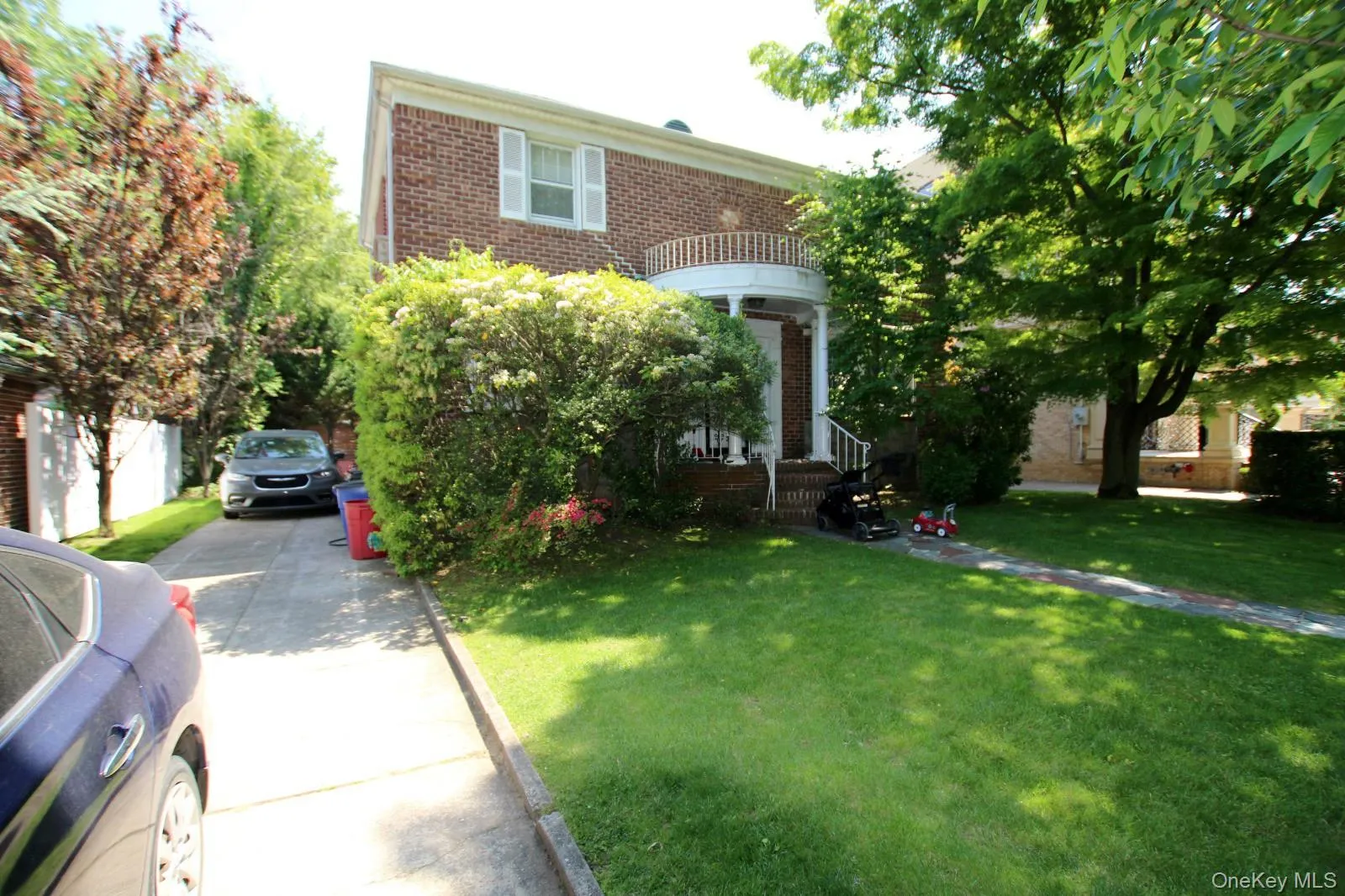 Brick facade home featuring a portico entry with balustrade details Brick facade home featuring a portico entry with balustrade details