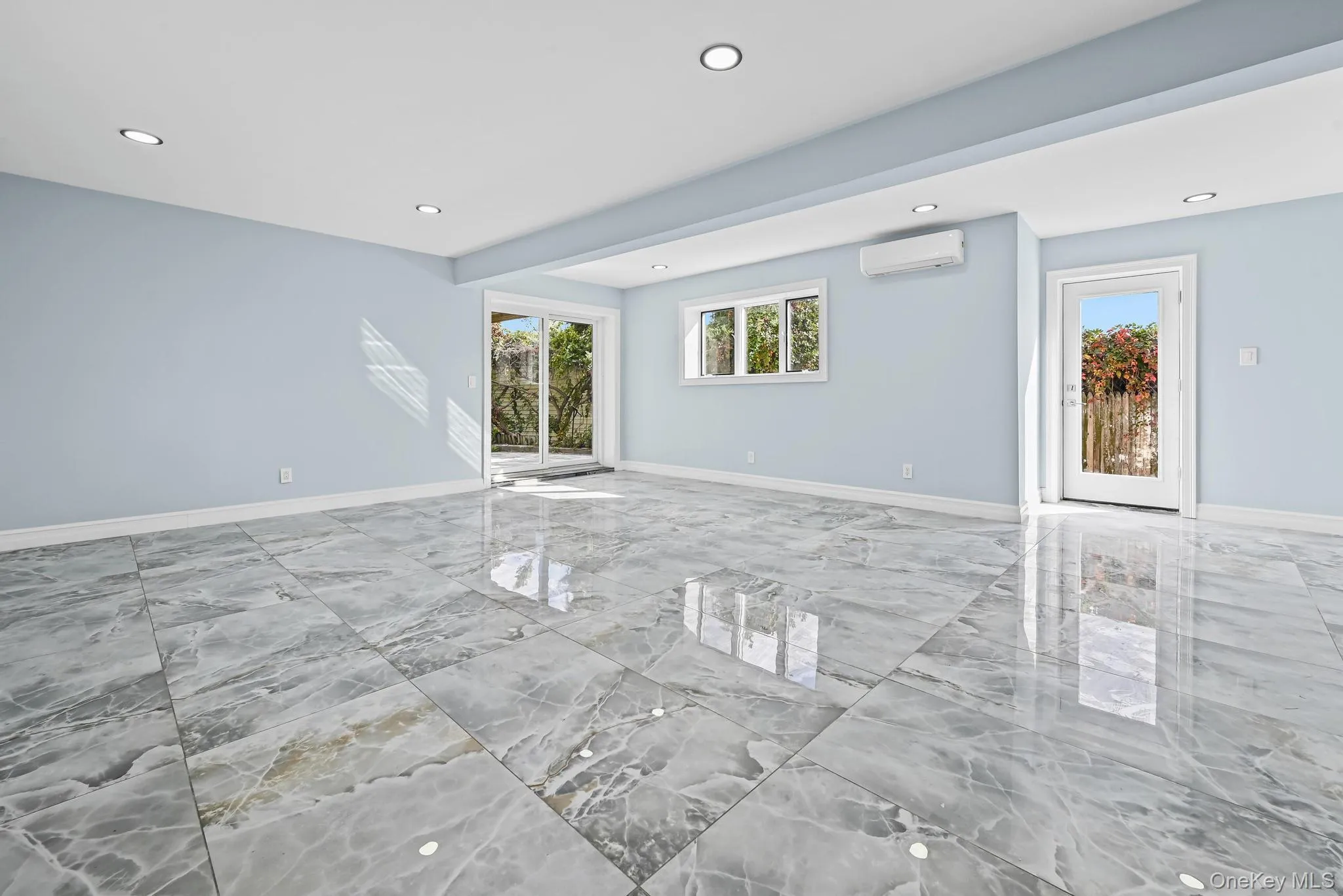 Spare room featuring light marble finish floors, healthy amount of natural light, and recessed lighting Spare room featuring light marble finish floors, healthy amount of natural light, and recessed lighting