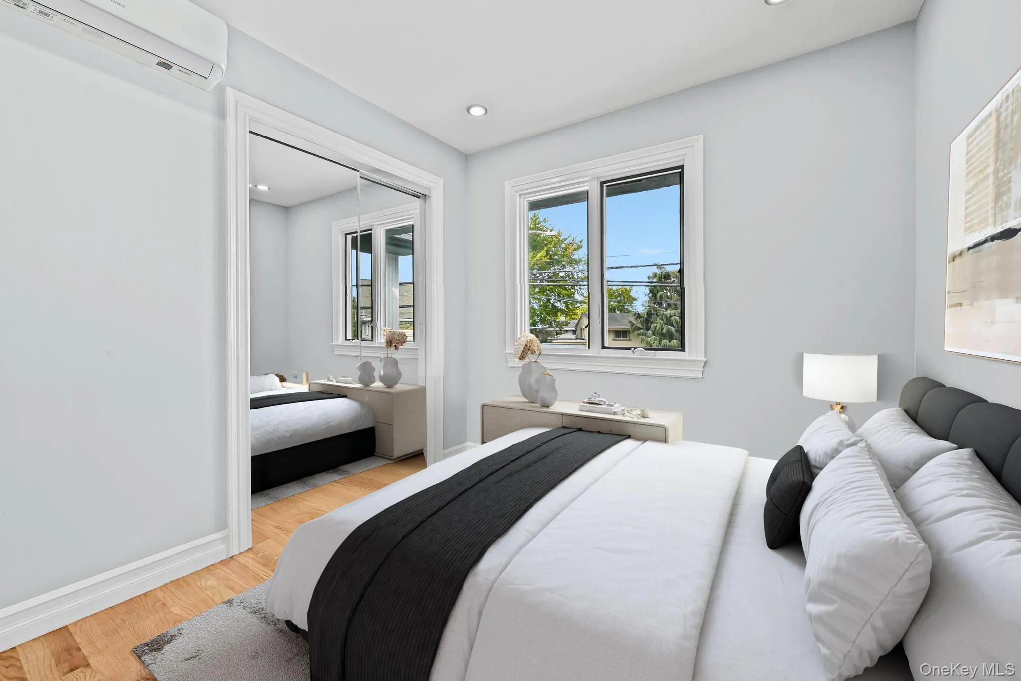 Bedroom with wood finished floors, a wall mounted air conditioner, recessed lighting, and a closet Bedroom with wood finished floors, a wall mounted air conditioner, recessed lighting, and a closet
