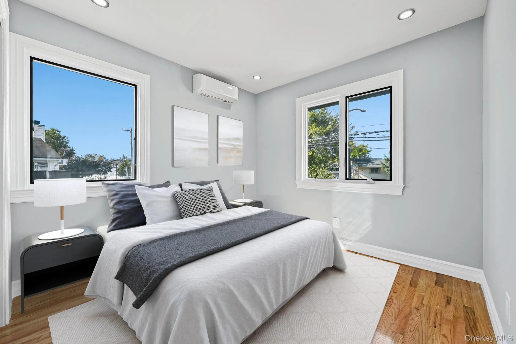 Bedroom with wood finished floors, recessed lighting, and a wall unit AC Bedroom with wood finished floors, recessed lighting, and a wall unit AC