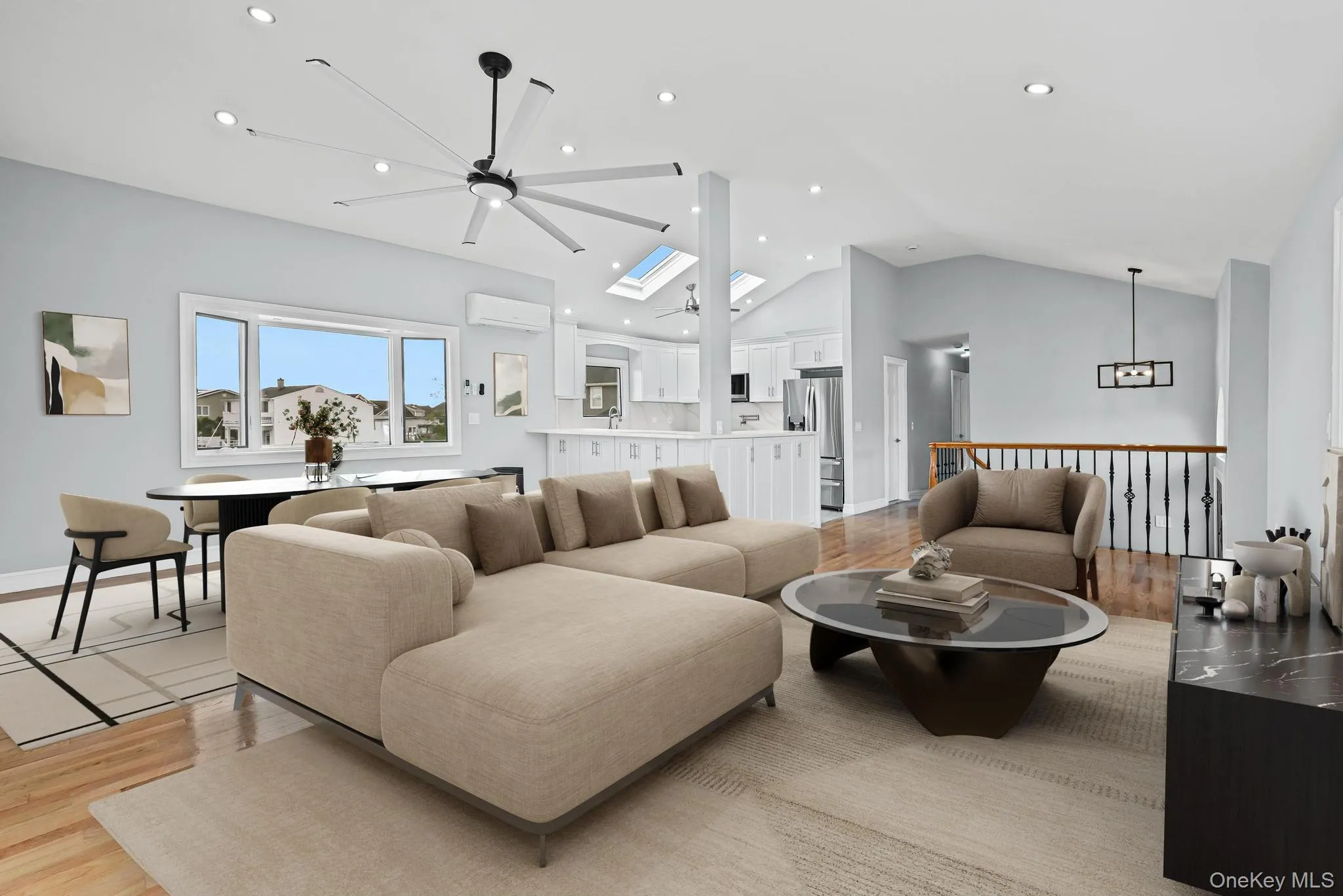 Living room featuring light wood-type flooring, lofted ceiling, ceiling fan, a skylight, and recessed lighting Living room featuring light wood-type flooring, lofted ceiling, ceiling fan, a skylight, and recessed lighting