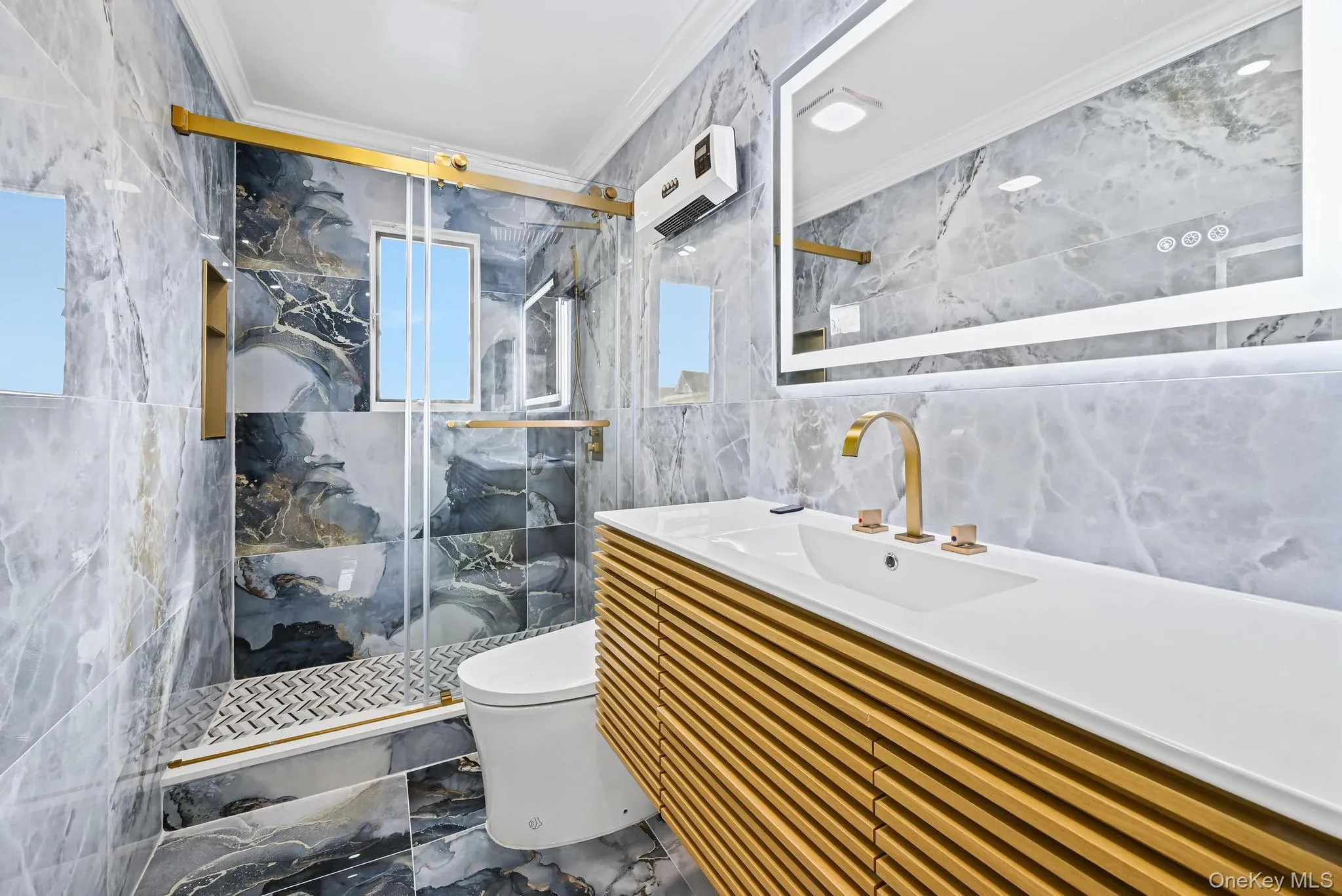 Bathroom with crown molding, tile walls, marble tiled flooring, a marble finish shower, and vanity Bathroom with crown molding, tile walls, marble tiled flooring, a marble finish shower, and vanity