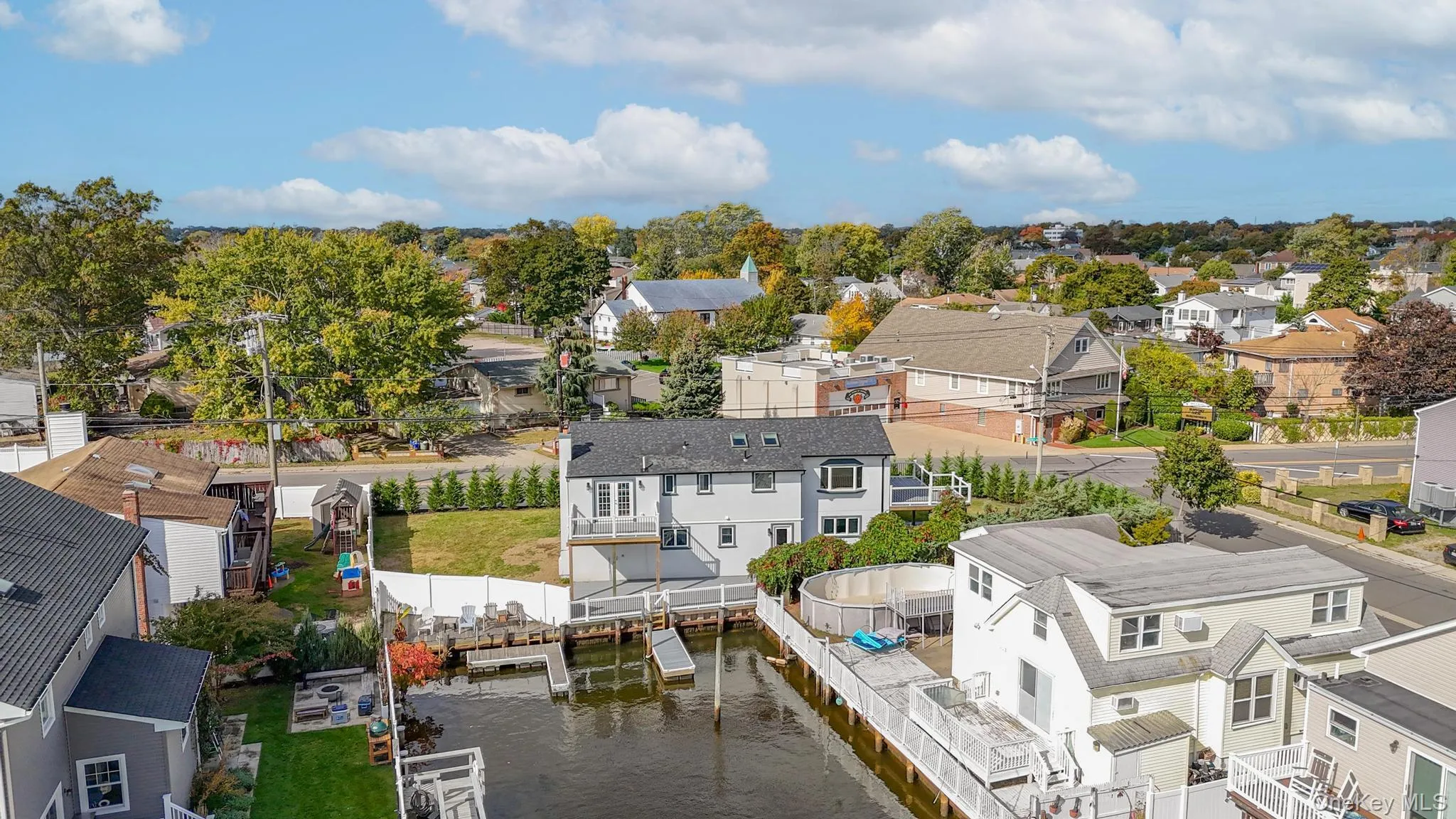 Aerial view of residential area with a nearby body of water Aerial view of residential area with a nearby body of water