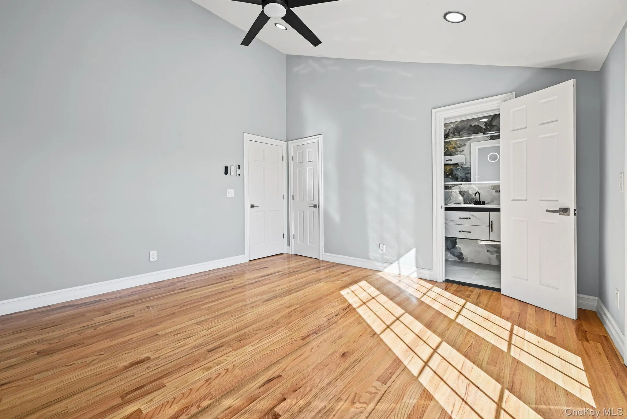 Spare room featuring light wood finished floors, high vaulted ceiling, a ceiling fan, and recessed lighting Spare room featuring light wood finished floors, high vaulted ceiling, a ceiling fan, and recessed lighting