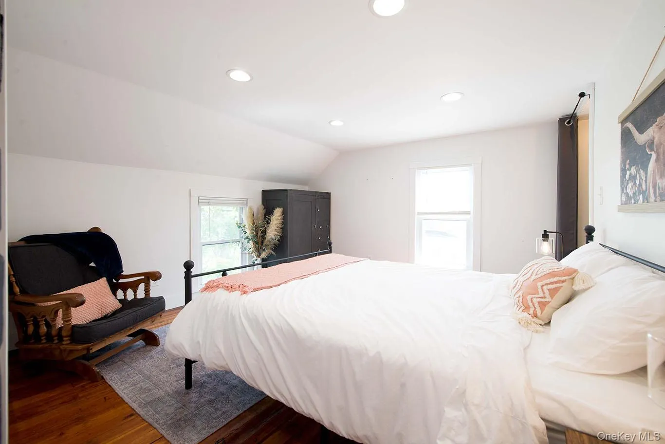 Interior room featuring hardwood flooring, recessed ceiling lighting, a window with blinds, and white painted walls Interior room featuring hardwood flooring, recessed ceiling lighting, a window with blinds, and white painted walls