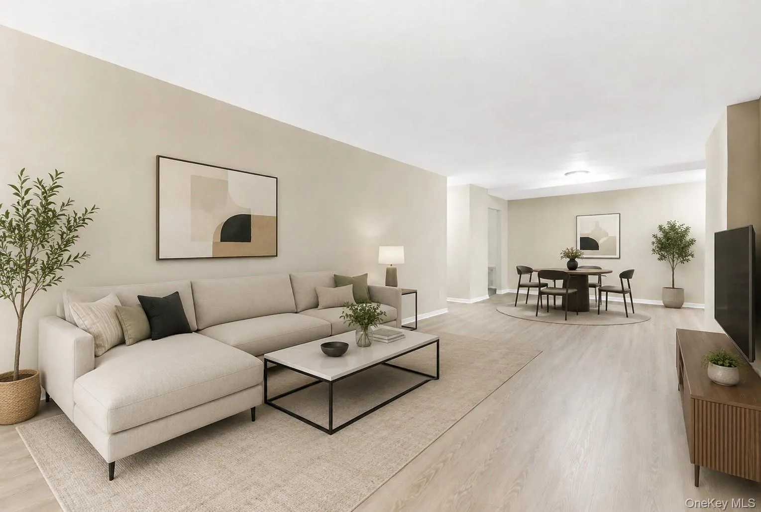 Spacious open-concept living area featuring light wood-finish flooring, neutral wall tones, recessed lighting, and ample natural light Spacious open-concept living area featuring light wood-finish flooring, neutral wall tones, recessed lighting, and ample natural light