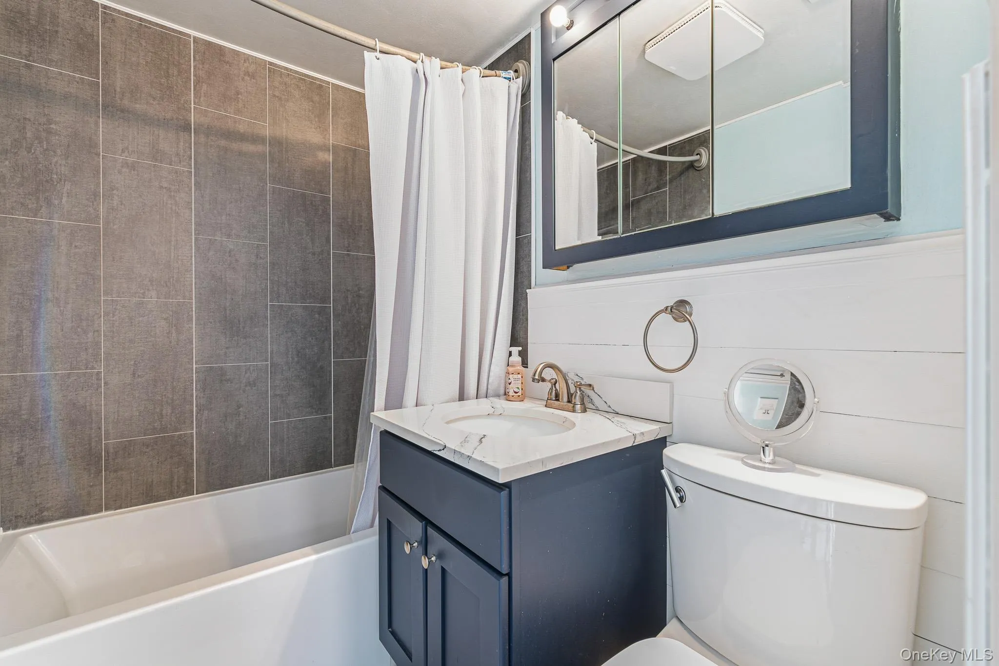 The Beautifully Upgraded Full/Guest Bathroom Offers A Full Bathtub with All Floor To Ceiling Fully Ceramic Tiled Walls/Tub Surround (All Large/Oversized Ceramic Tile), Shiplap Accent Walls, Ceramic Tiled Floor, And An Upgraded Vanity, Medicine Cabinet & Fixtures. The Beautifully Upgraded Full/Guest Bathroom Offers A Full Bathtub with All Floor To Ceiling Fully Ceramic Tiled Walls/Tub Surround (All Large/Oversized Ceramic Tile), Shiplap Accent Walls, Ceramic Tiled Floor, And An Upgraded Vanity, Medicine Cabinet & Fixtures.
