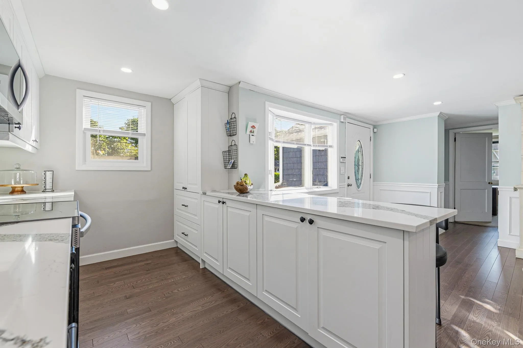 The Stunning Two Year Old Custom Kitchen Offers Walls Of White Shaker Style Cabinetry With Large Pot Drawers & Ample Storage, Accent Quartz Countertops With A Farm Sink & Large Barstool/Counter & Serving Space, Hardwood Floors, Recessed Lighting, Beautiful Crown Moldings, All Stainless Steel Appliances (Including A Samsung Ceramic Top Stove, LG Built In Microwave Oven, LG French Door Refrigerator With Bottom Freezer, Water & Ice Maker, And LG Dishwasher), And An Opening/Pass Through Into The Dining Room. The Stunning Two Year Old Custom Kitchen Offers Walls Of White Shaker Style Cabinetry With Large Pot Drawers & Ample Storage, Accent Quartz Countertops With A Farm Sink & Large Barstool/Counter & Serving Space, Hardwood Floors, Recessed Lighting, Beautiful Crown Moldings, All Stainless Steel Appliances (Including A Samsung Ceramic Top Stove, LG Built In Microwave Oven, LG French Door Refrigerator With Bottom Freezer, Water & Ice Maker, And LG Dishwasher), And An Opening/Pass Through Into The Dining Room.