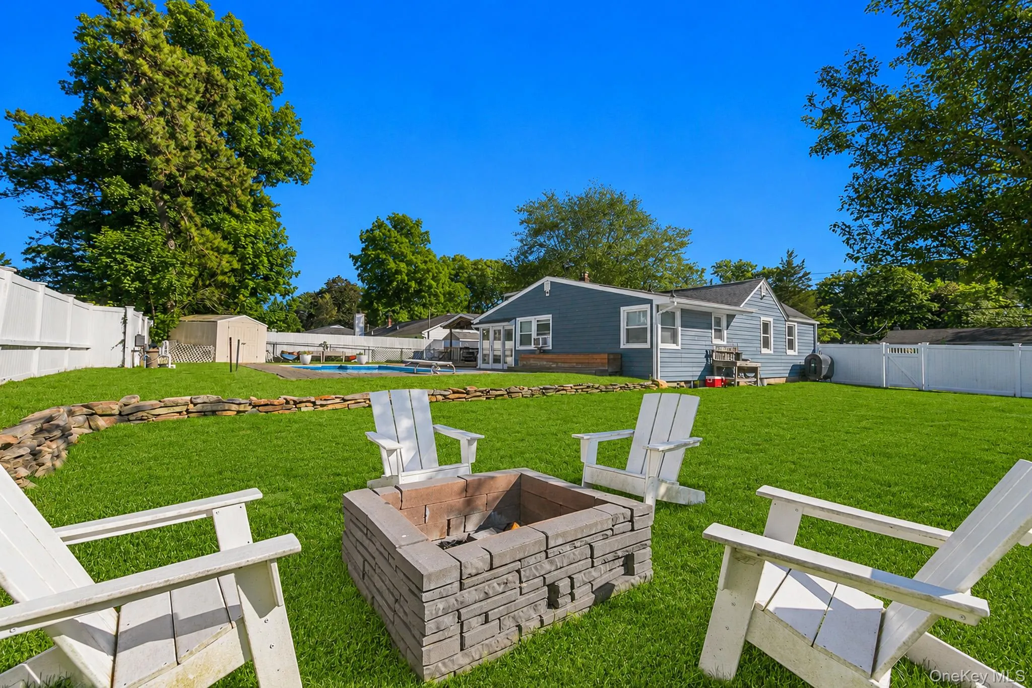 The Large Fully PVC Fenced Backyard Also Has Beautiful Stone/Rock Walls, Expansive Lawns/Beautiful Grasses With Ample Room For Entertaining, And A Firepit Area. The Large Fully PVC Fenced Backyard Also Has Beautiful Stone/Rock Walls, Expansive Lawns/Beautiful Grasses With Ample Room For Entertaining, And A Firepit Area.