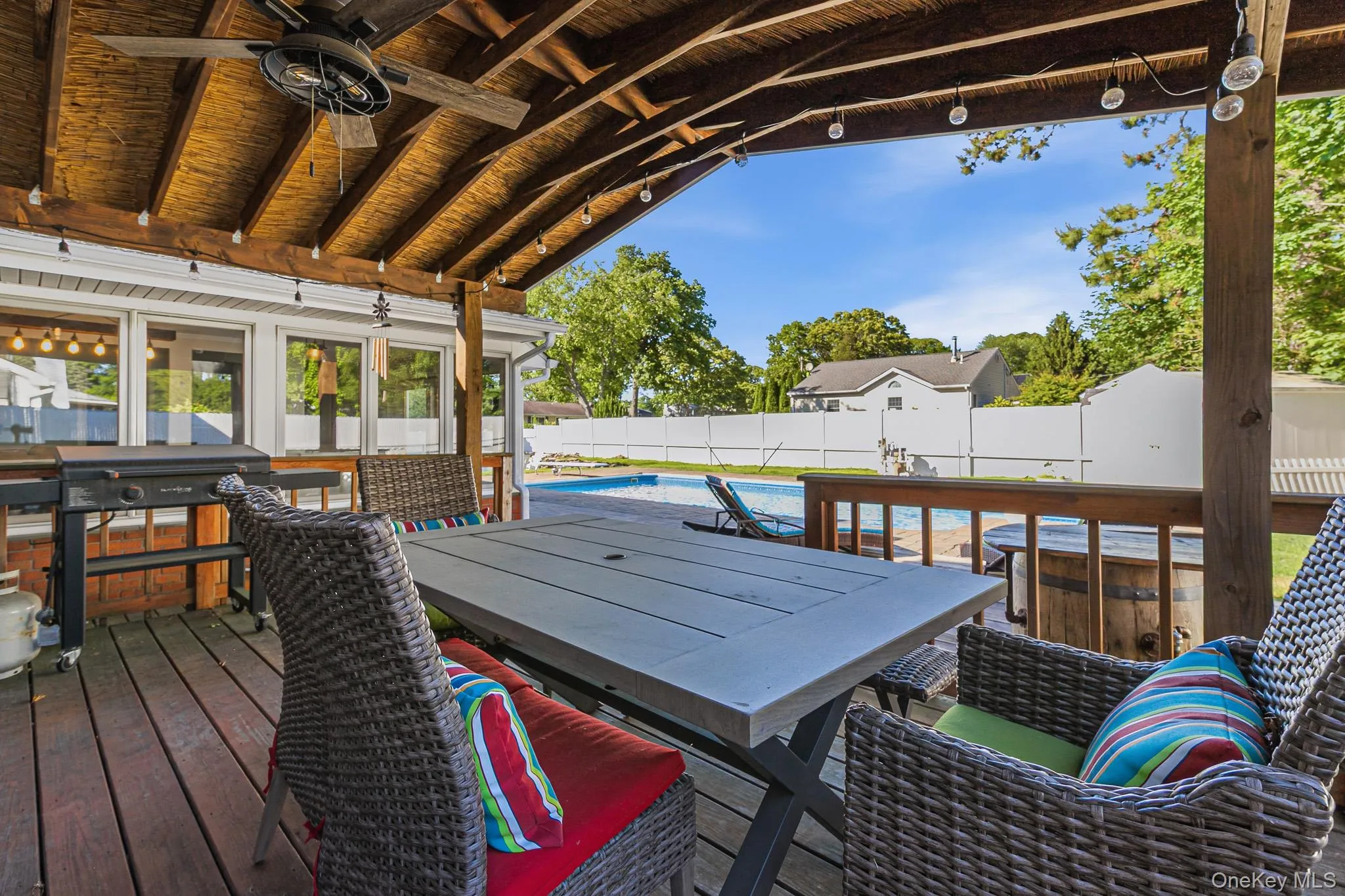 Off Of The Dining Room & Overlooking The Saltwater In Ground Pool Is A Fantastic Covered Deck With Electric & A Ceiling Fan...Perfect For Outdoor Entertaining And Barbequing! Off Of The Dining Room & Overlooking The Saltwater In Ground Pool Is A Fantastic Covered Deck With Electric & A Ceiling Fan...Perfect For Outdoor Entertaining And Barbequing!