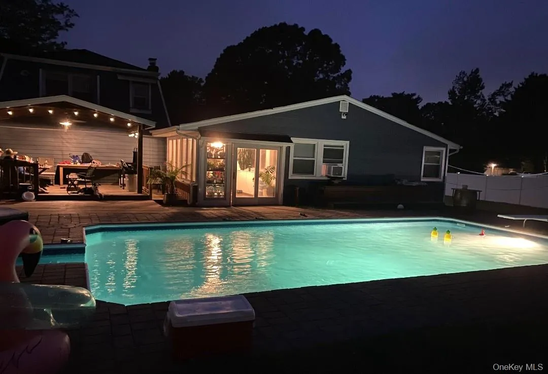 Nighttime View Of The Saltwater In Ground Pool & Lighted Covered Deck. Nighttime View Of The Saltwater In Ground Pool & Lighted Covered Deck.