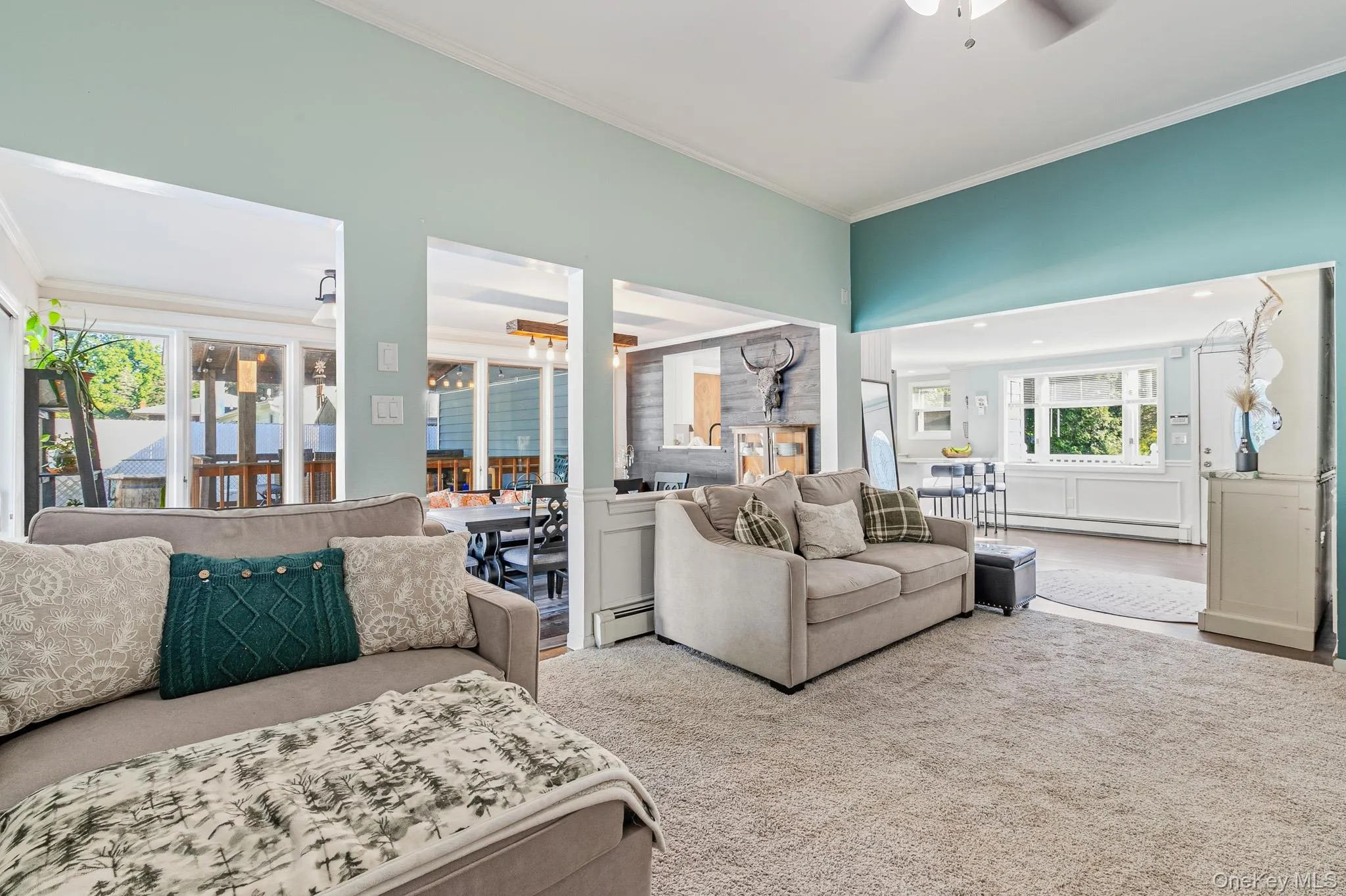 Off Of The Entrance Foyer Is The Comfortable & Inviting Formal Living Room Offering Volume/High Ceilings, Beautiful Box Paneled/Wainscoted Walls, Two Large Windows For Natural Light (Overlooking The Backyard), Updated Carpeting, Ceiling Fan, And An Open Flow Into The Step Down Formal Dining Room With Beautiful Cut Outs/Open Walls & An Open Doorway. Off Of The Entrance Foyer Is The Comfortable & Inviting Formal Living Room Offering Volume/High Ceilings, Beautiful Box Paneled/Wainscoted Walls, Two Large Windows For Natural Light (Overlooking The Backyard), Updated Carpeting, Ceiling Fan, And An Open Flow Into The Step Down Formal Dining Room With Beautiful Cut Outs/Open Walls & An Open Doorway.