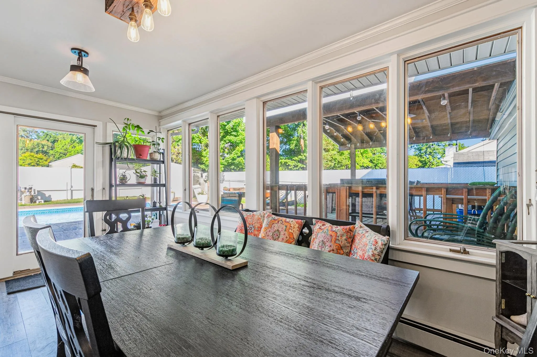 Another View Of The Stunning Step Down Formal Dining Room Offering Walls Of Windows & Sliding Doors Overlooking The Backyard & In Ground Pool, Beautiful Moldings & Details, Accent Shiplap Wall With An Opening Into The Kitchen, Chandelier & Ample Room For A Good Sized Table & Chairs. This Room Would Also Make A Perfect Den/Sunroom With All Of It's Beautiful Windows & Access To The Backyard & Pool. Another View Of The Stunning Step Down Formal Dining Room Offering Walls Of Windows & Sliding Doors Overlooking The Backyard & In Ground Pool, Beautiful Moldings & Details, Accent Shiplap Wall With An Opening Into The Kitchen, Chandelier & Ample Room For A Good Sized Table & Chairs. This Room Would Also Make A Perfect Den/Sunroom With All Of It's Beautiful Windows & Access To The Backyard & Pool.