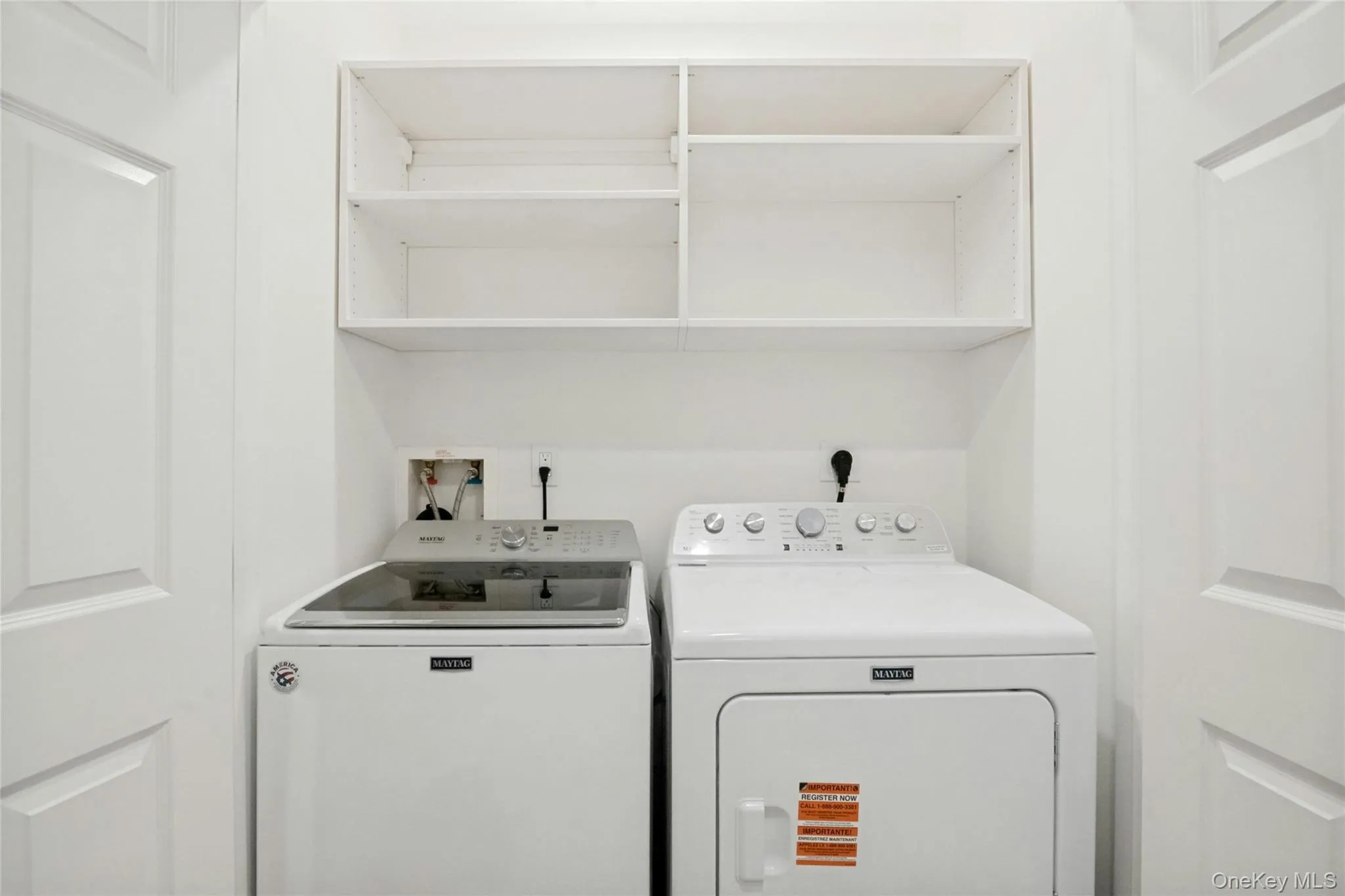 In-closet multi function washer and dryer with convenient shelving overhead In-closet multi function washer and dryer with convenient shelving overhead