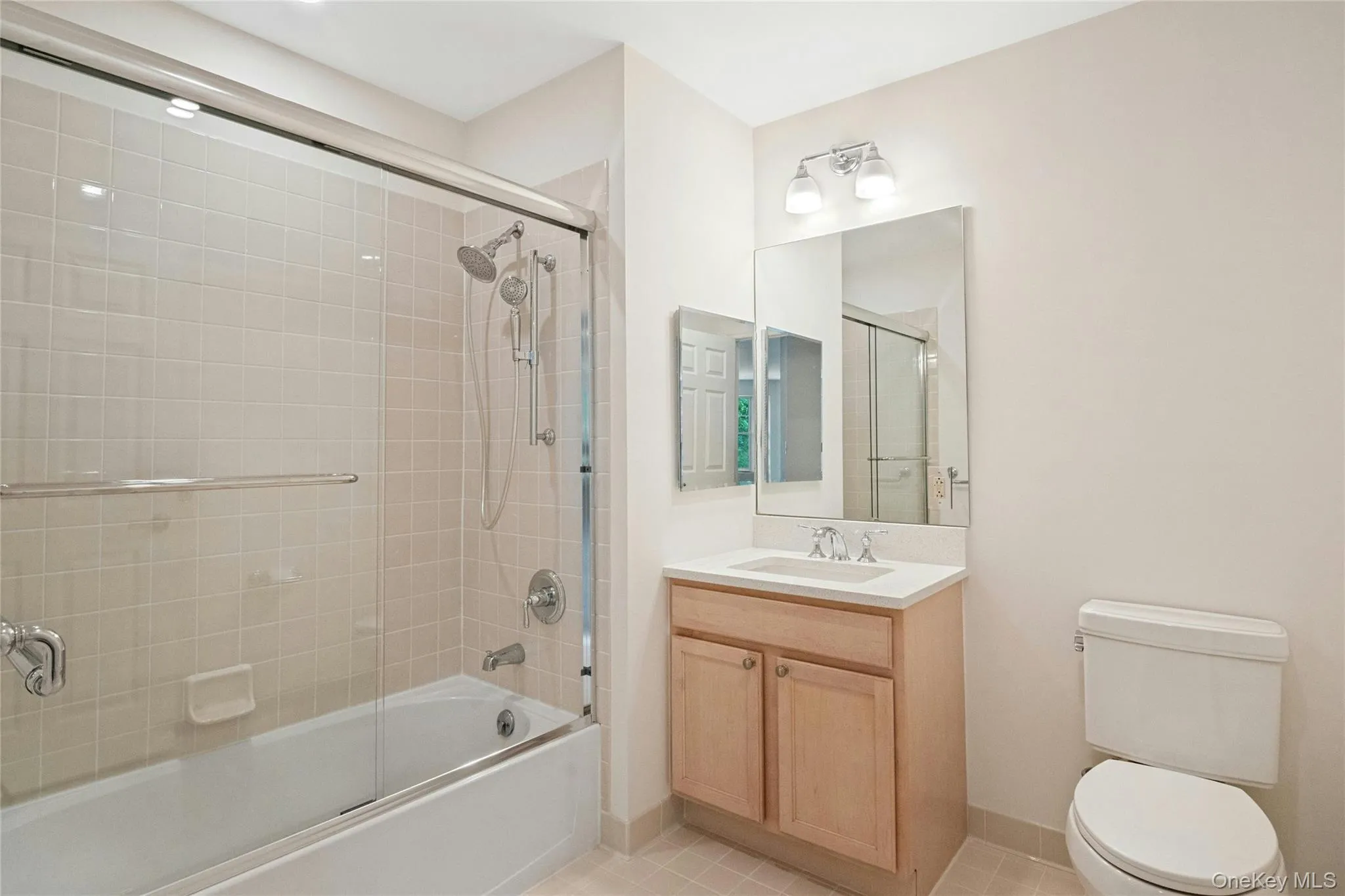 Updated 2nd bathroom with new glass shower doors, new bath light fixtures, vanity with wood cabinetry, and new white quartz countertop Updated 2nd bathroom with new glass shower doors, new bath light fixtures, vanity with wood cabinetry, and new white quartz countertop