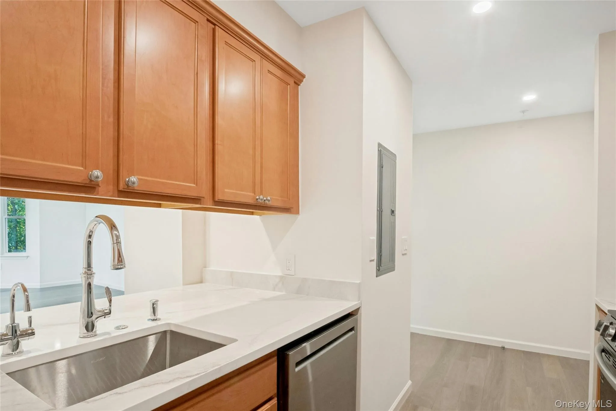 Kitchen featuring Kohler faucet with pull down spray, sink with hot water dispenser and new dishwasher Kitchen featuring Kohler faucet with pull down spray, sink with hot water dispenser and new dishwasher