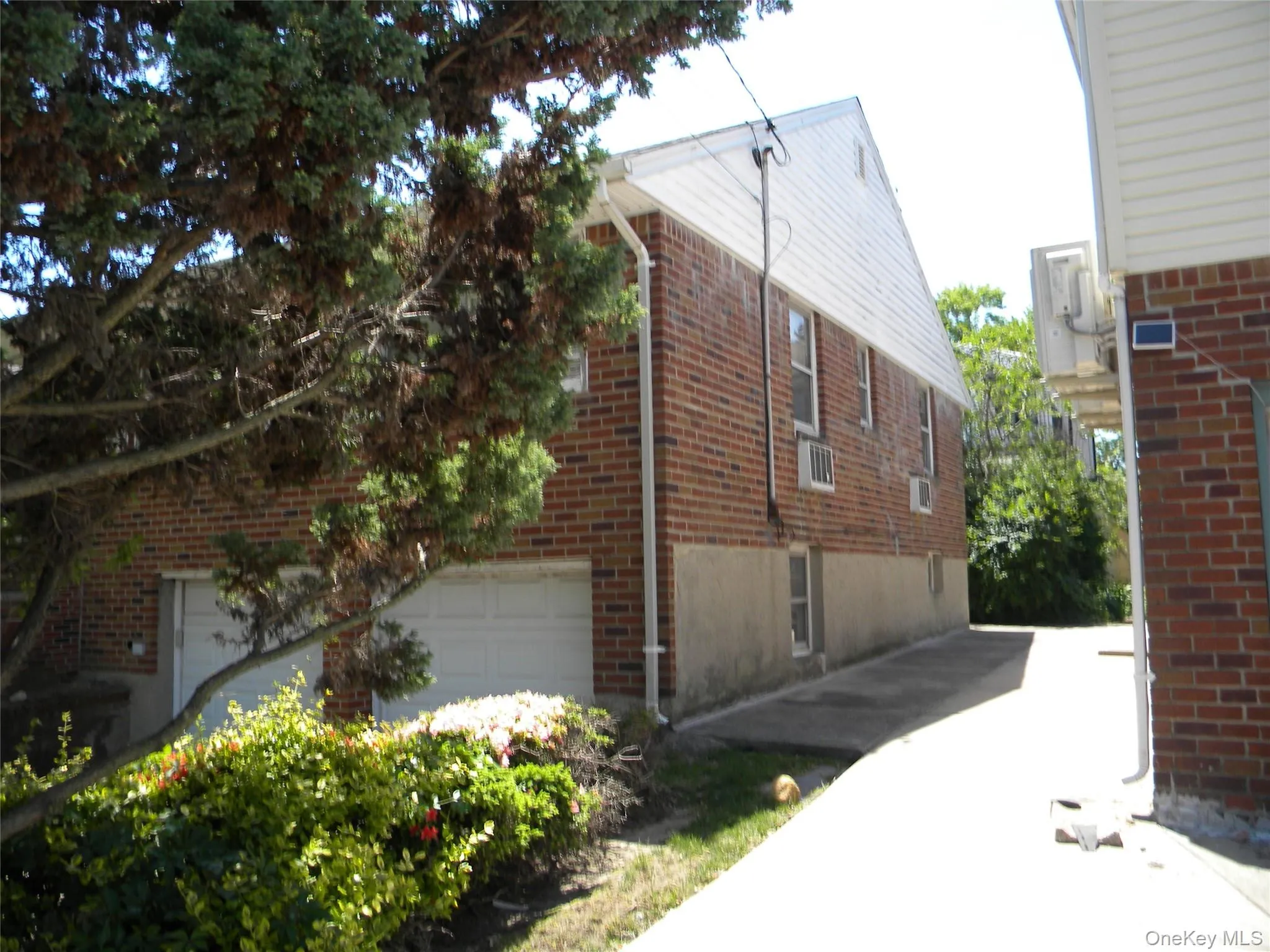 Brick exterior with white siding accents and multiple windows Brick exterior with white siding accents and multiple windows