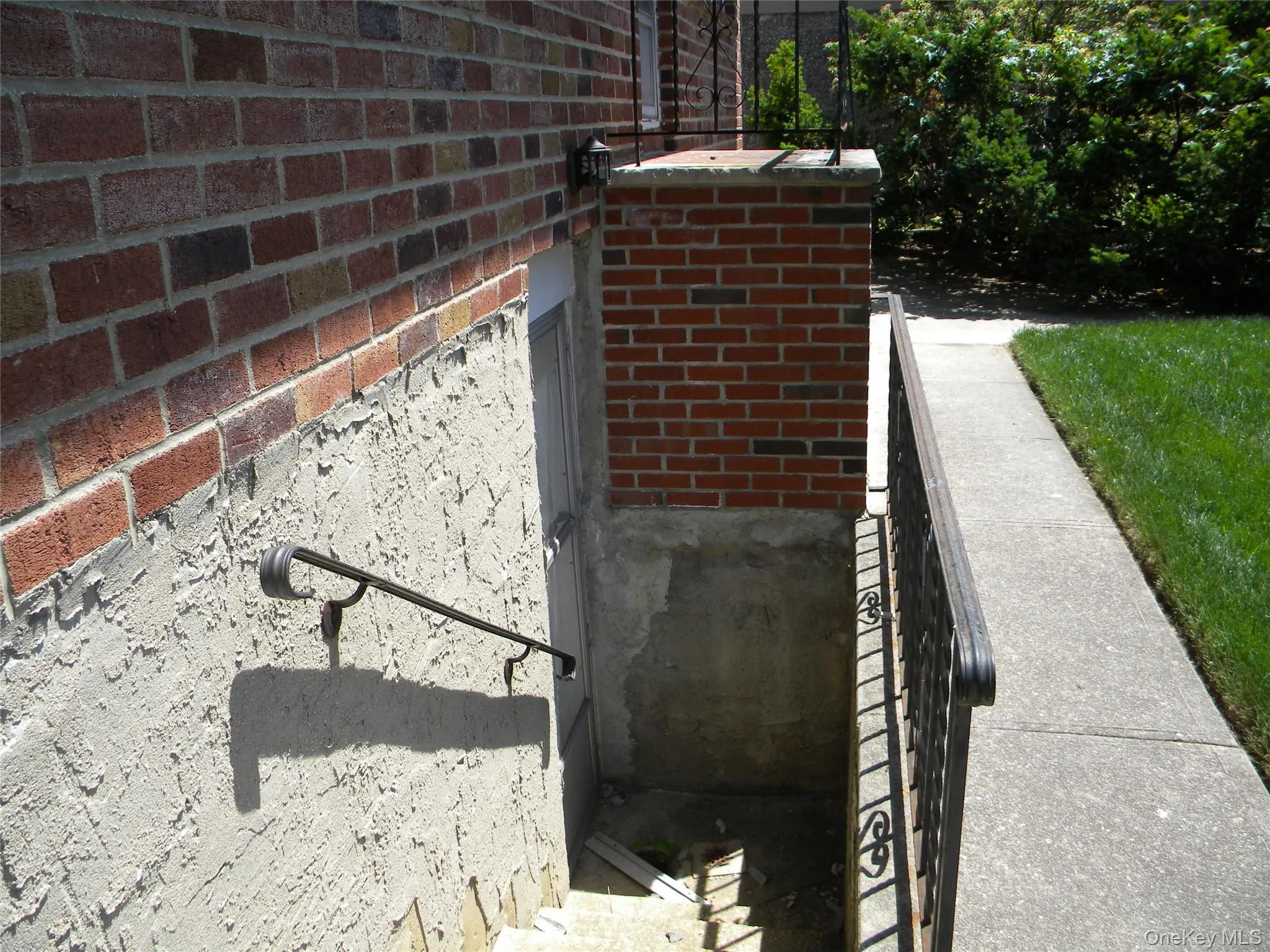 stairway/egressBrick exterior with stucco foundation stairway/egressBrick exterior with stucco foundation