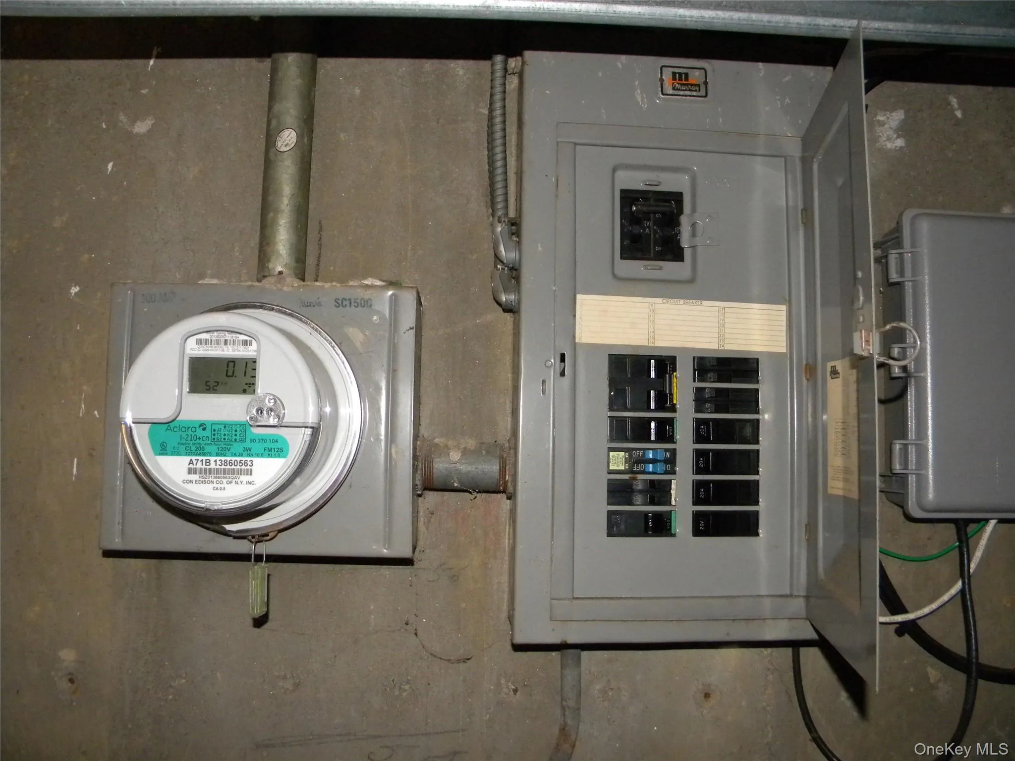 Electrical panel and digital utility meter on a concrete wall Electrical panel and digital utility meter on a concrete wall