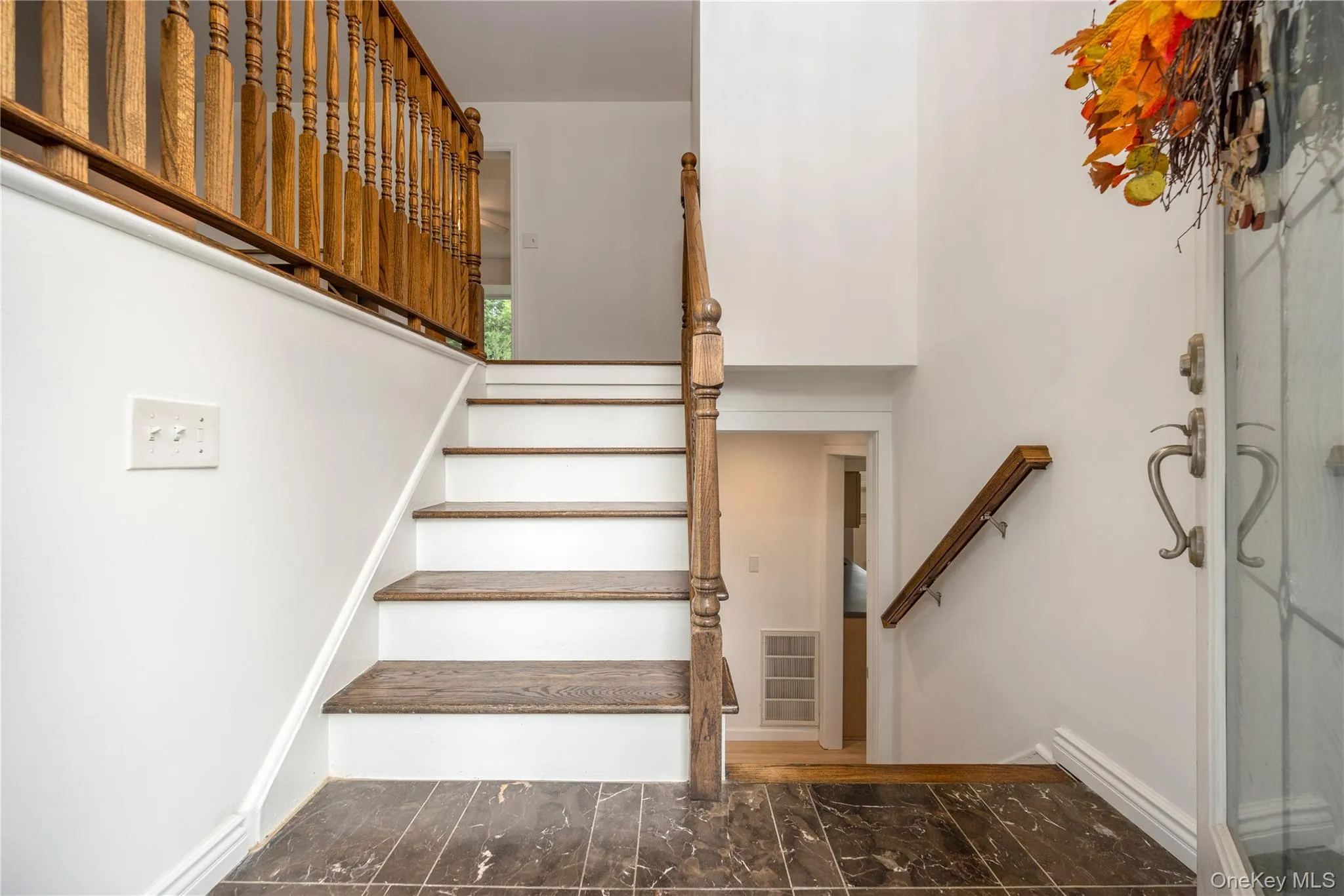 Tiled entry with oak banisters Tiled entry with oak banisters