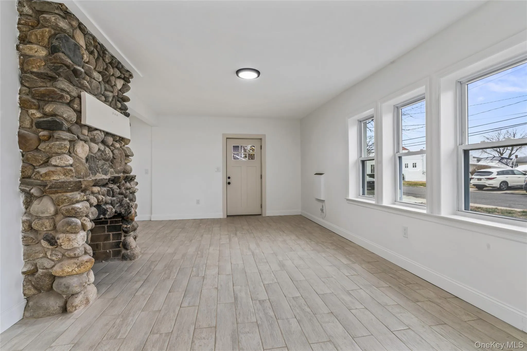 Entryway with wood tiled floors and a fireplace Entryway with wood tiled floors and a fireplace