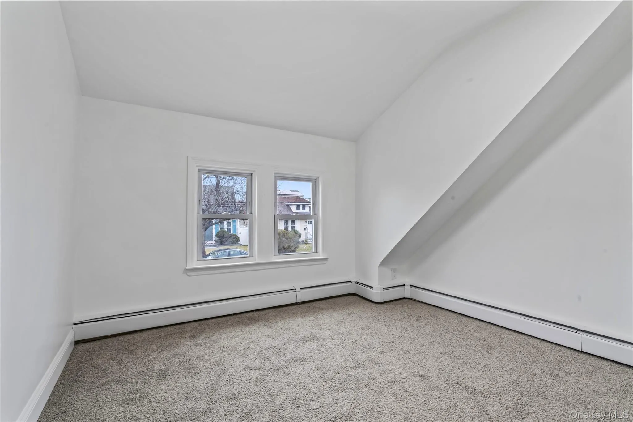 Additional living space with carpet floors and a baseboard heating unit Additional living space with carpet floors and a baseboard heating unit