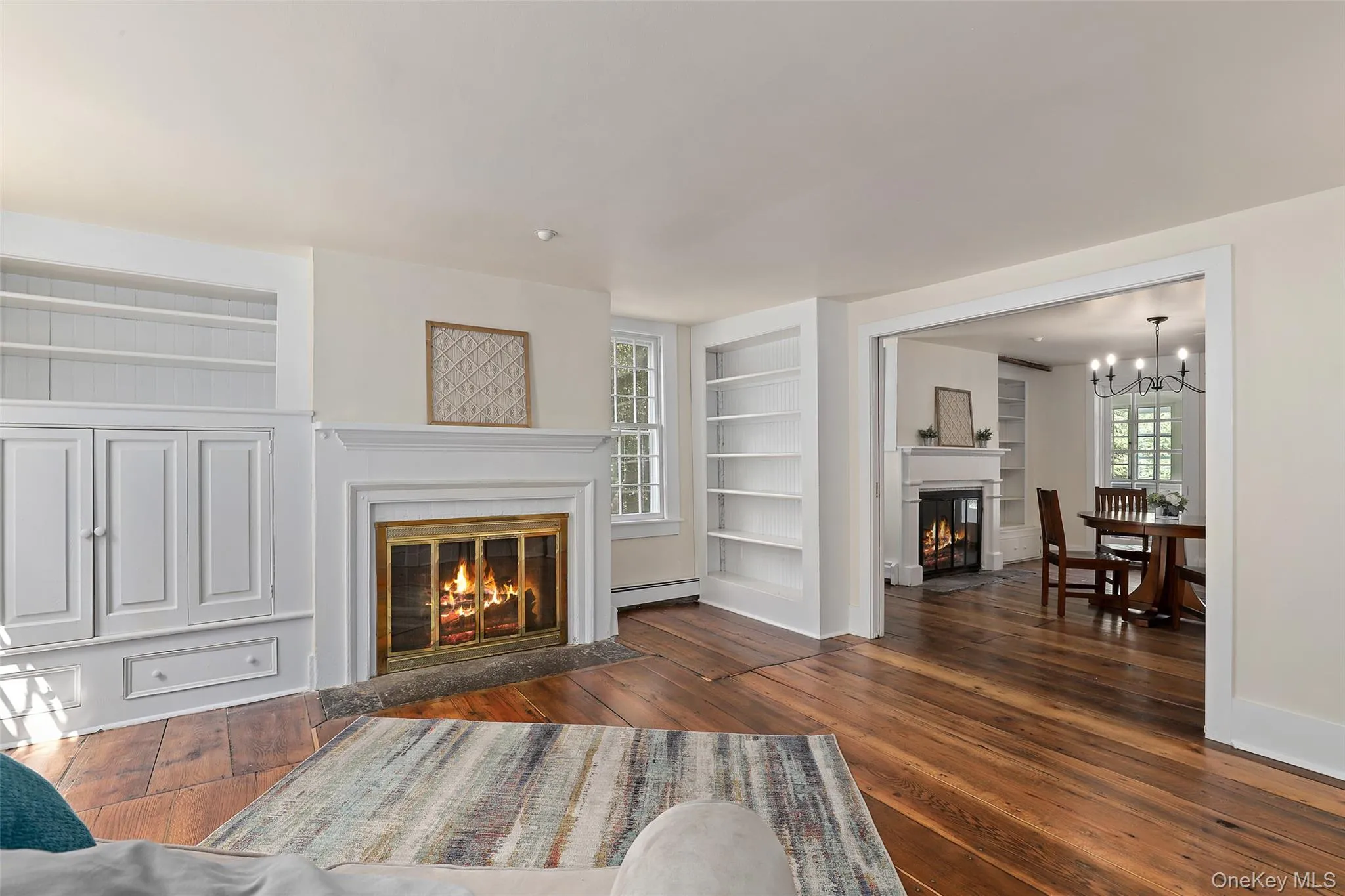 Wood burning fire place in the formal living room open to dining room with pocket doors Wood burning fire place in the formal living room open to dining room with pocket doors