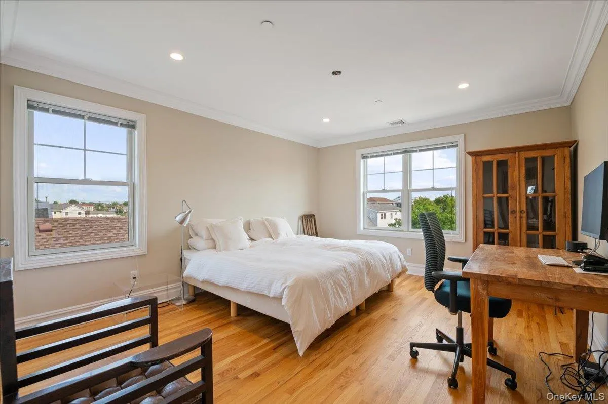 Bedroom with light wood-type flooring, an office area, recessed lighting, and ornamental molding Bedroom with light wood-type flooring, an office area, recessed lighting, and ornamental molding