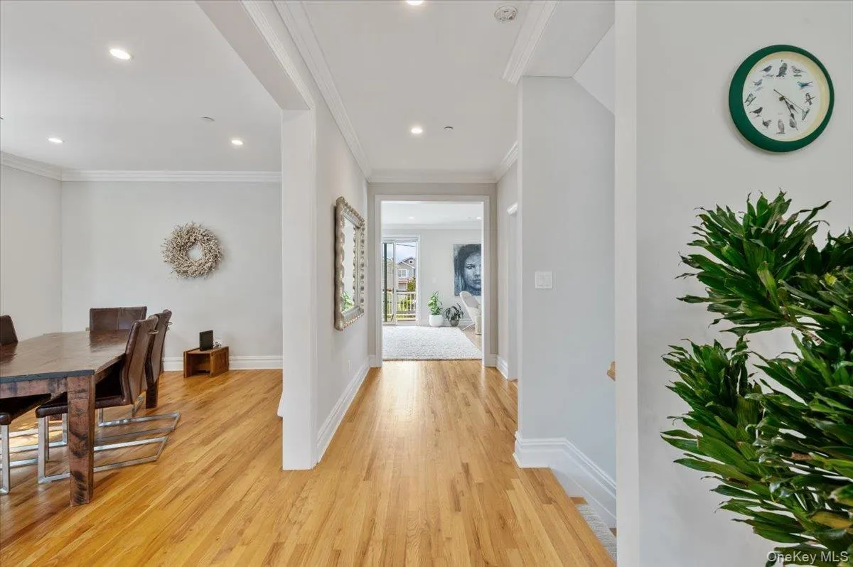Hallway featuring light wood finished floors, recessed lighting, and crown molding Hallway featuring light wood finished floors, recessed lighting, and crown molding