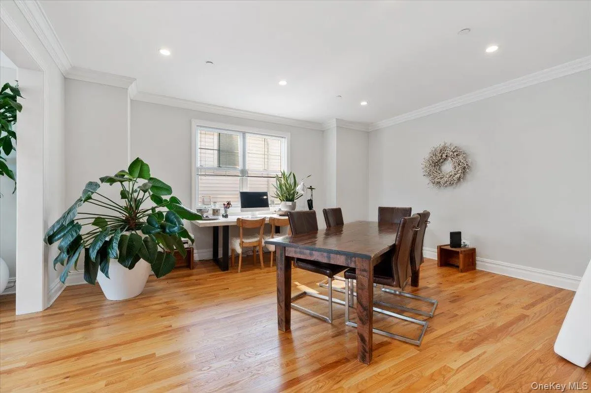 Dining area with light wood-style flooring, ornamental molding, recessed lighting, and a desk Dining area with light wood-style flooring, ornamental molding, recessed lighting, and a desk