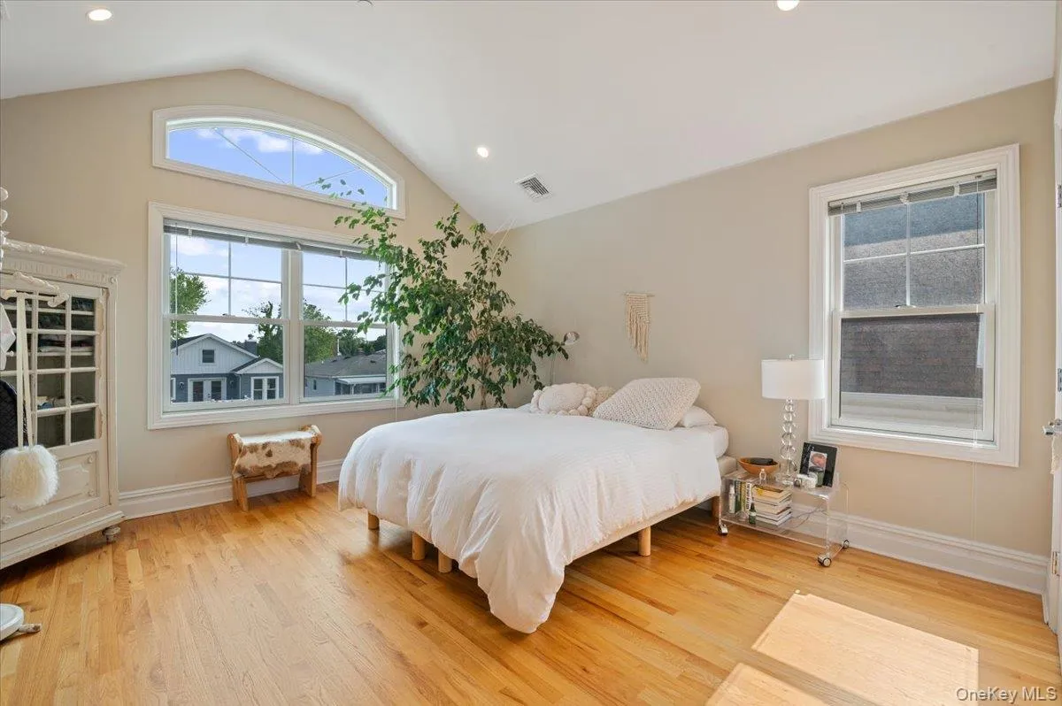 Bedroom with lofted ceiling, light wood-type flooring, and recessed lighting Bedroom with lofted ceiling, light wood-type flooring, and recessed lighting