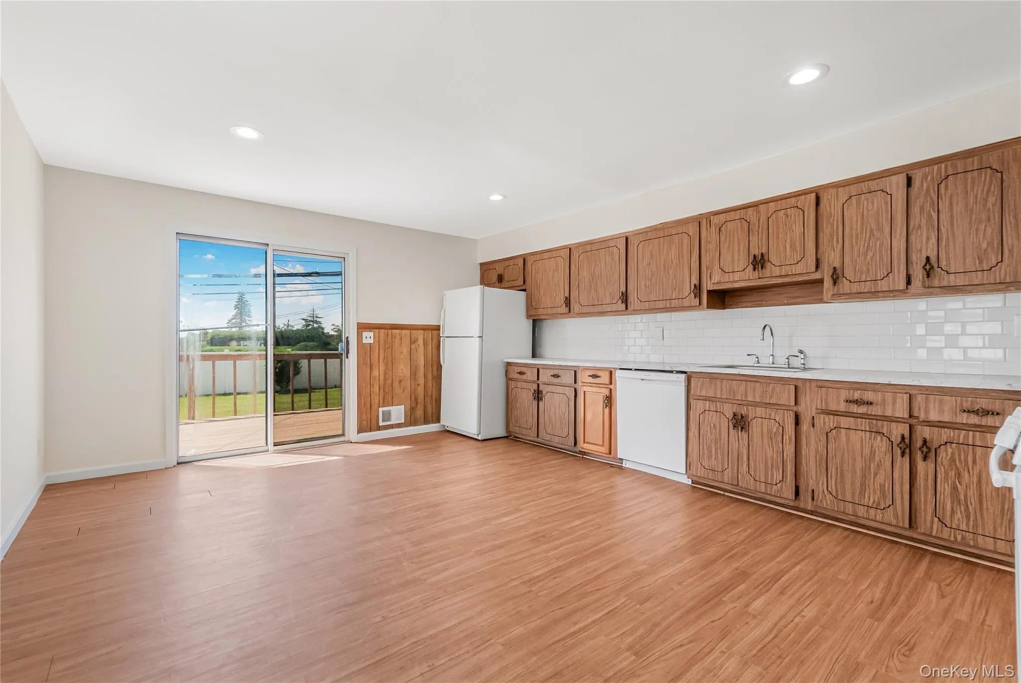 Generous size kitchen with a slider to the rear yard and deck Generous size kitchen with a slider to the rear yard and deck