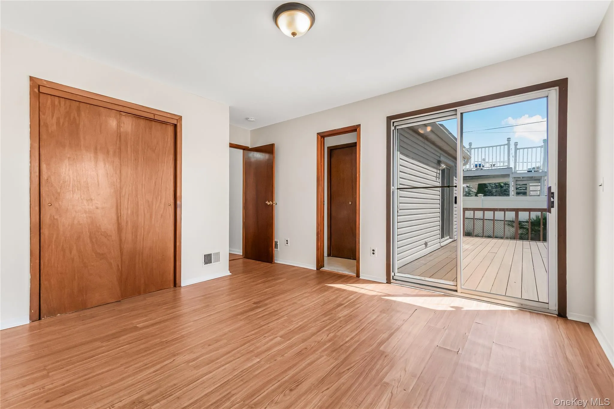 Bedroom # 3 on first floor with access to rear yard and deck Bedroom # 3 on first floor with access to rear yard and deck