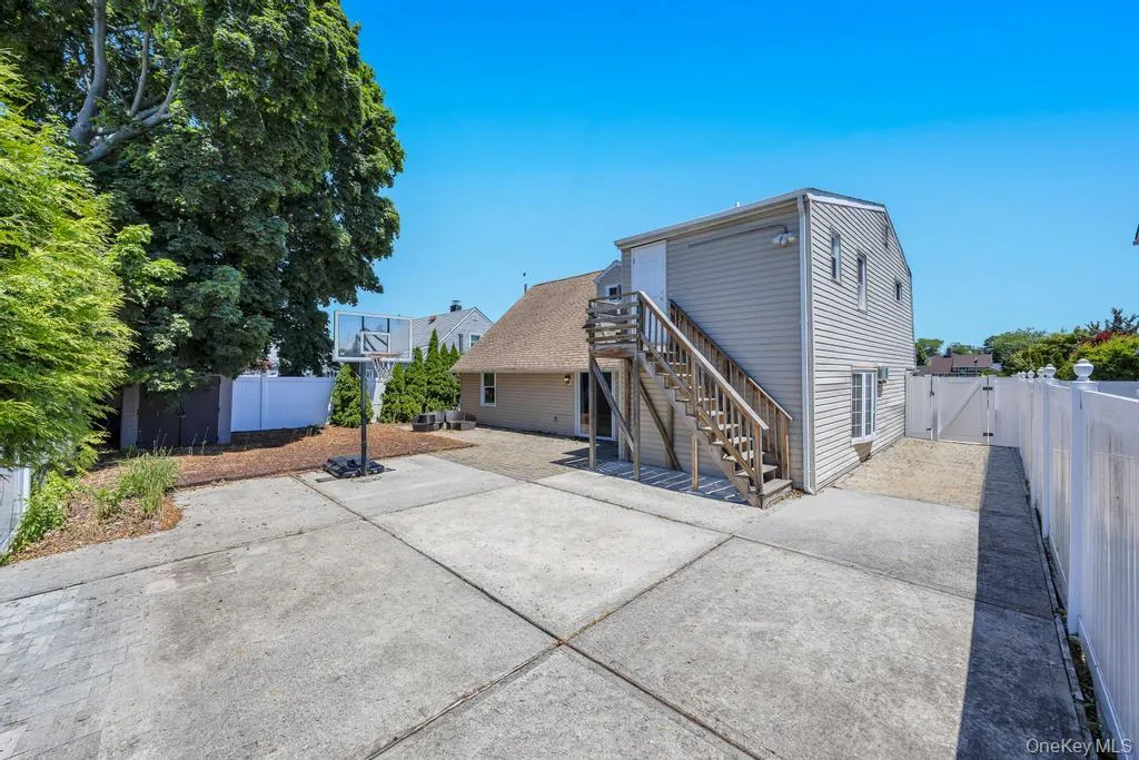 Expansive concrete patio area with a privacy fence Expansive concrete patio area with a privacy fence