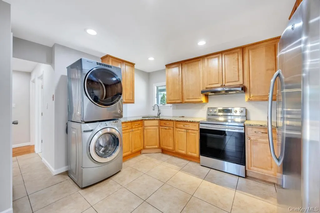 Kitchen featuring abundant wood cabinetry, recessed lighting, and tile flooring Kitchen featuring abundant wood cabinetry, recessed lighting, and tile flooring