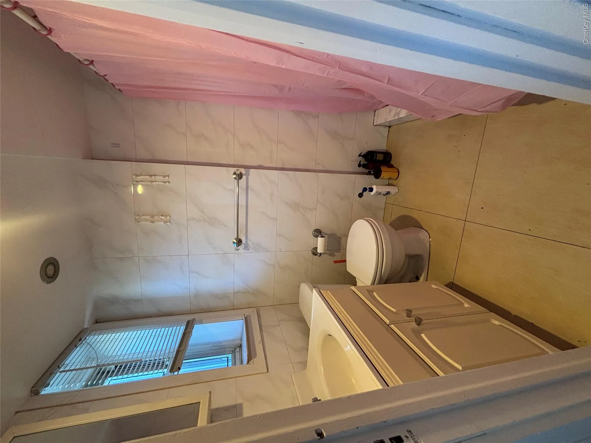 Bathroom featuring a single vanity, toilet, and a tiled shower area Bathroom featuring a single vanity, toilet, and a tiled shower area