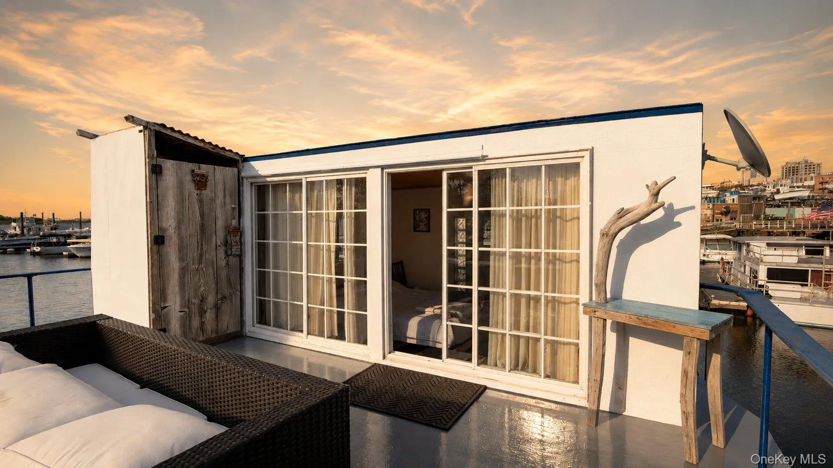 Outdoor deck with water access, featuring sliding glass doors. Outdoor deck with water access, featuring sliding glass doors.